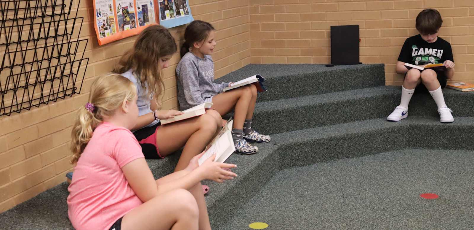 East Goshen Elementary School students read books in the school library.