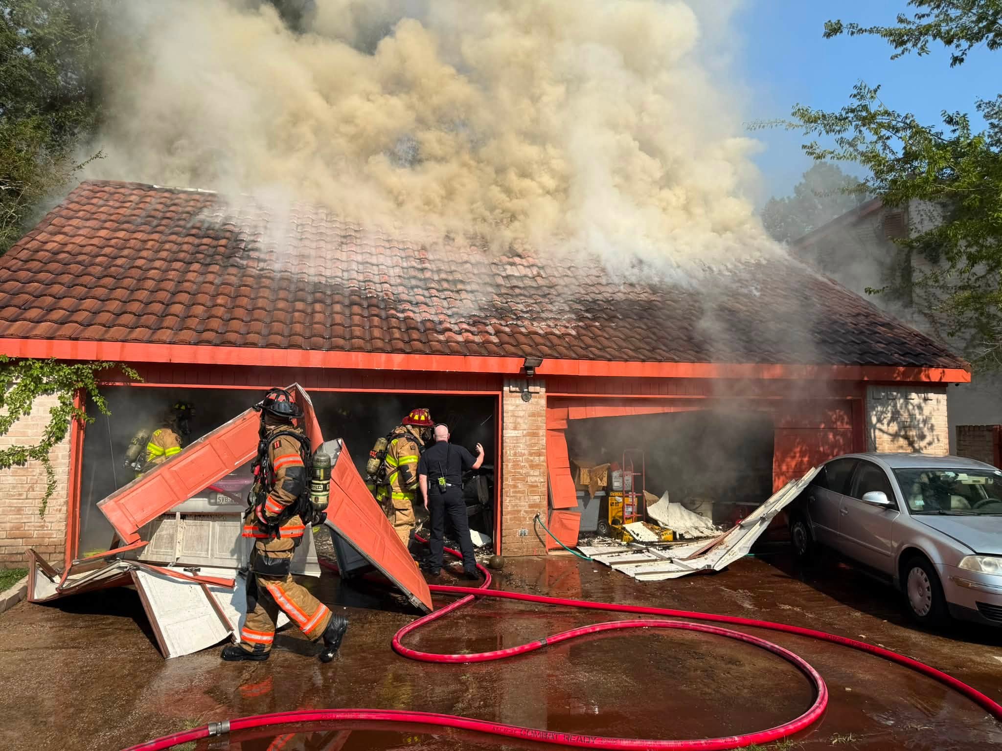Smoke billowing into sky as firefighters work to put out fire at home in Texas.