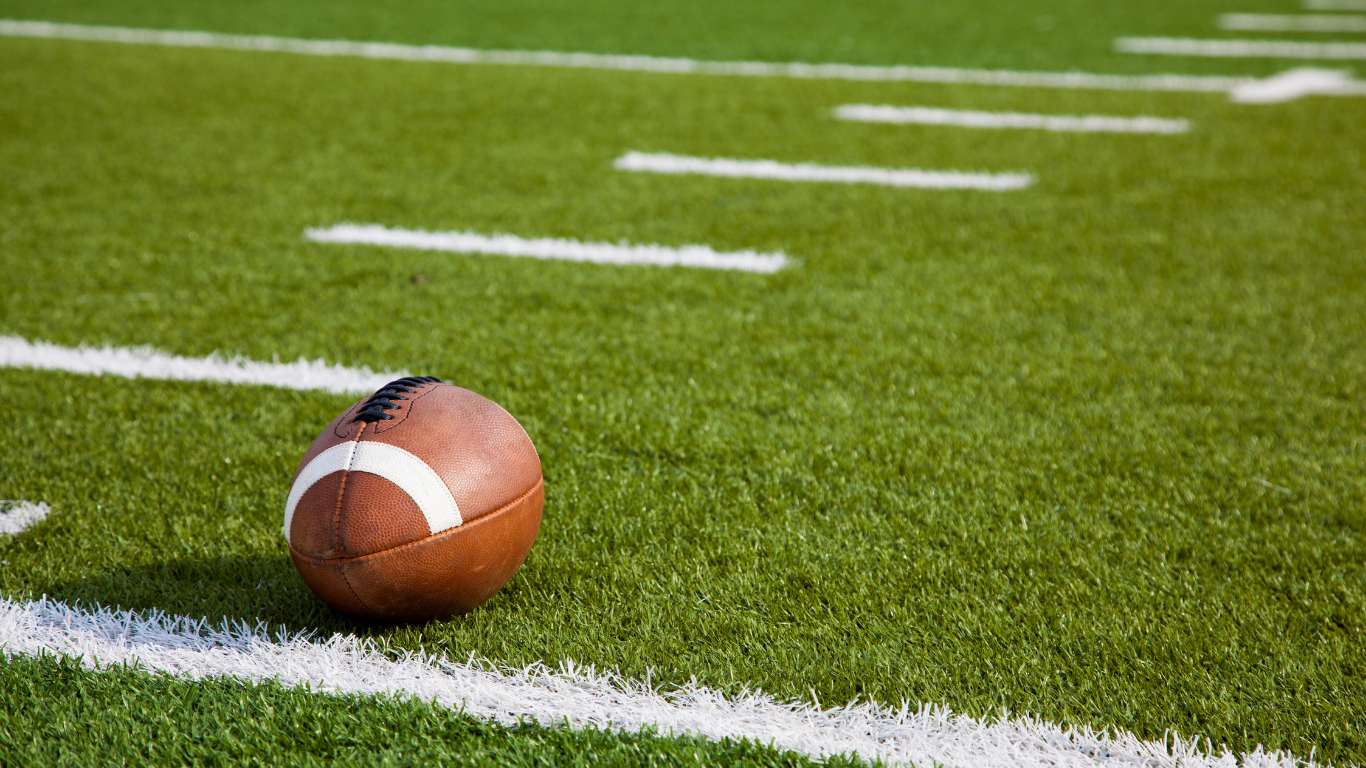 Football on yard line on field.