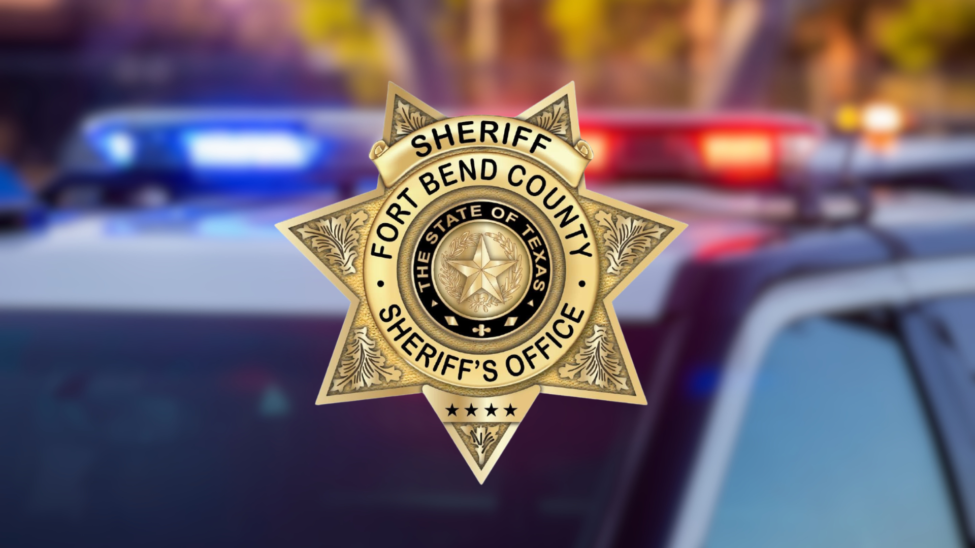 The Fort Bend County Sheriff's Office Bage Logo on Blurred Police Vehicle background.