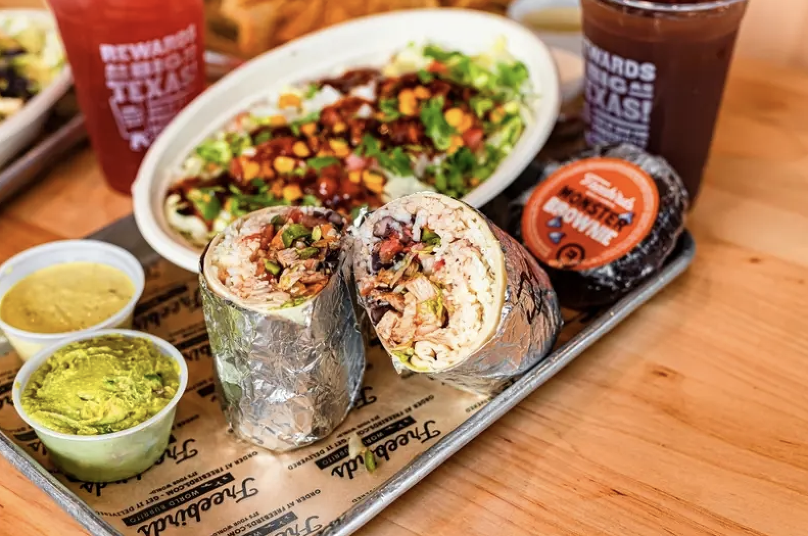 Burrito bowl and burrito lunch with soda