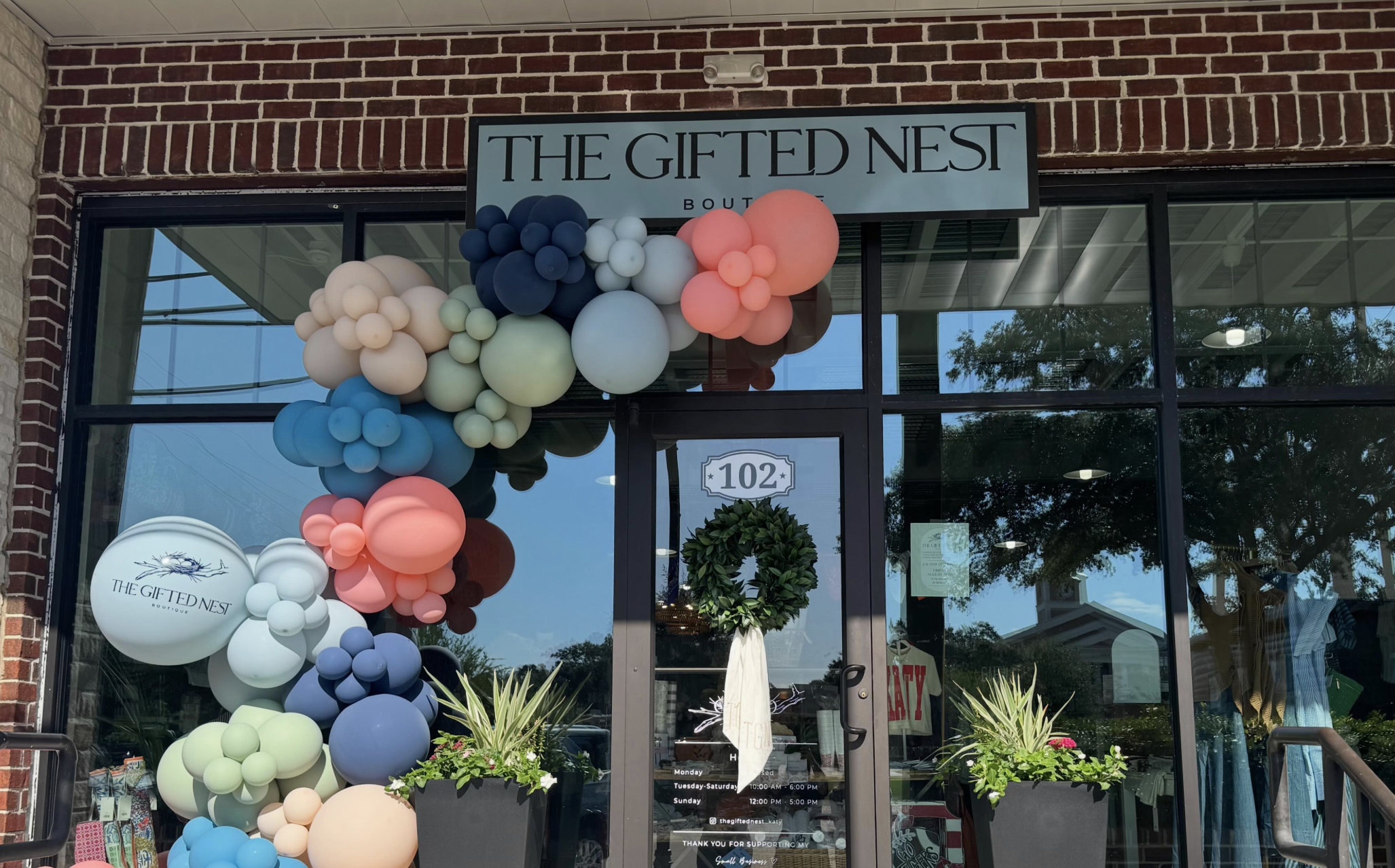 Balloon arch sits outside store front for opening business.