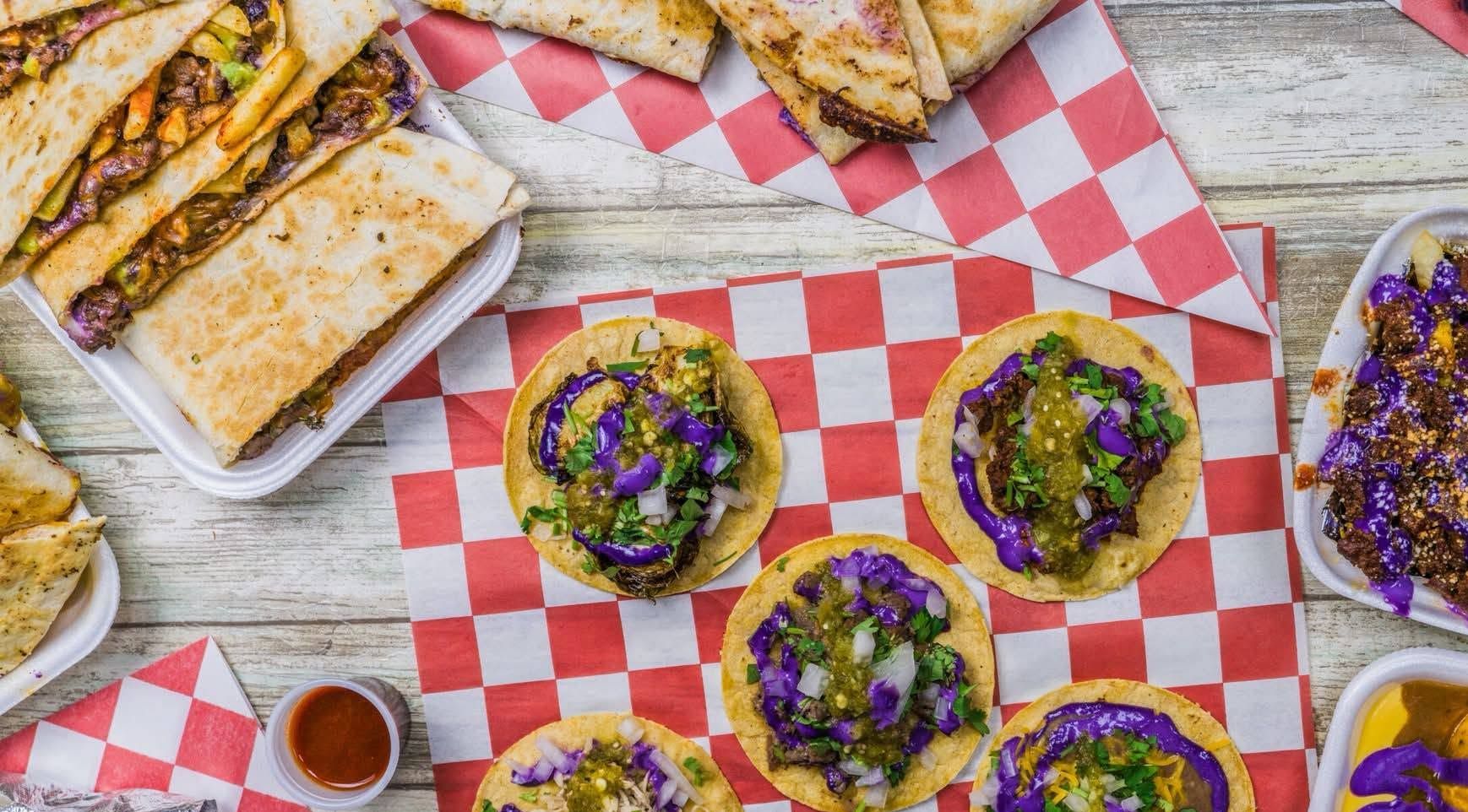 Tacos on plate in restaurant with checkered background