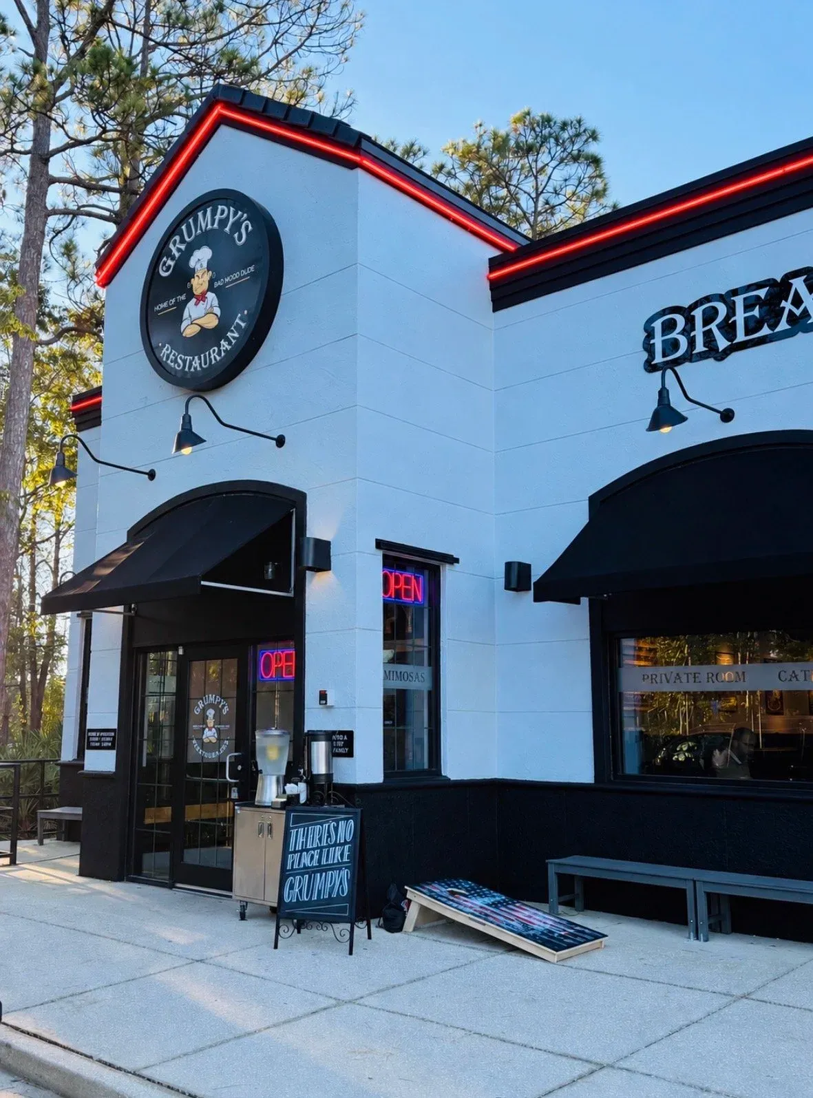 Exterior of Grumpy’s Restaurant on Fleming Island, showing the entrance, restaurant sign and black awnings.