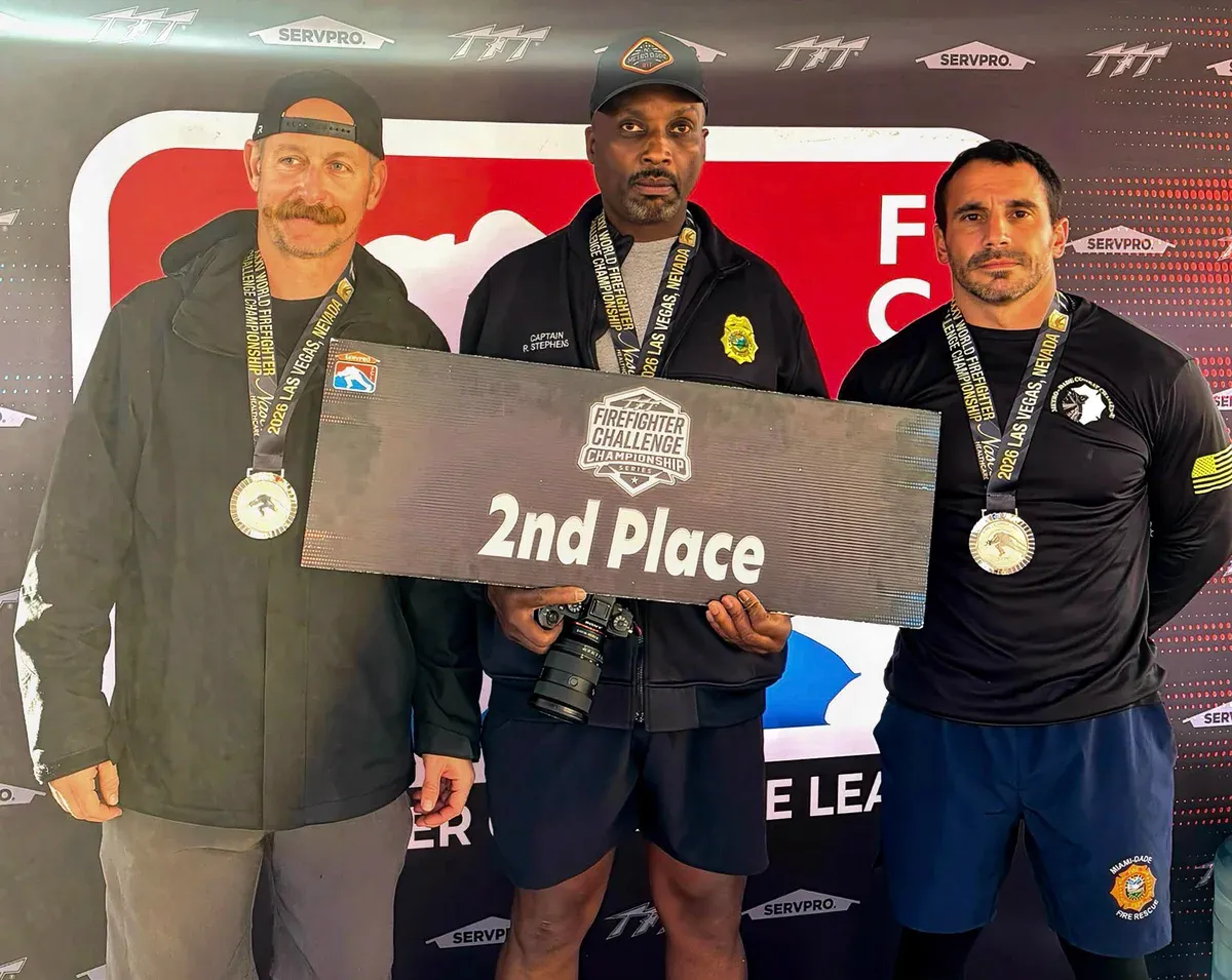 Three Miami-Dade Fire Rescue members pose with a second-place award at the 2026 World Firefighter Challenge.