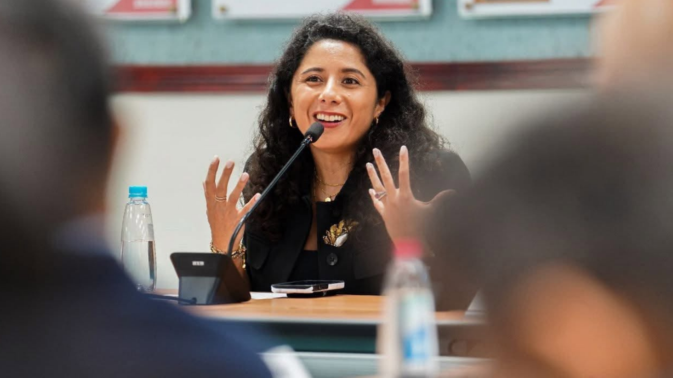 Woman speaking at event on the microphone
