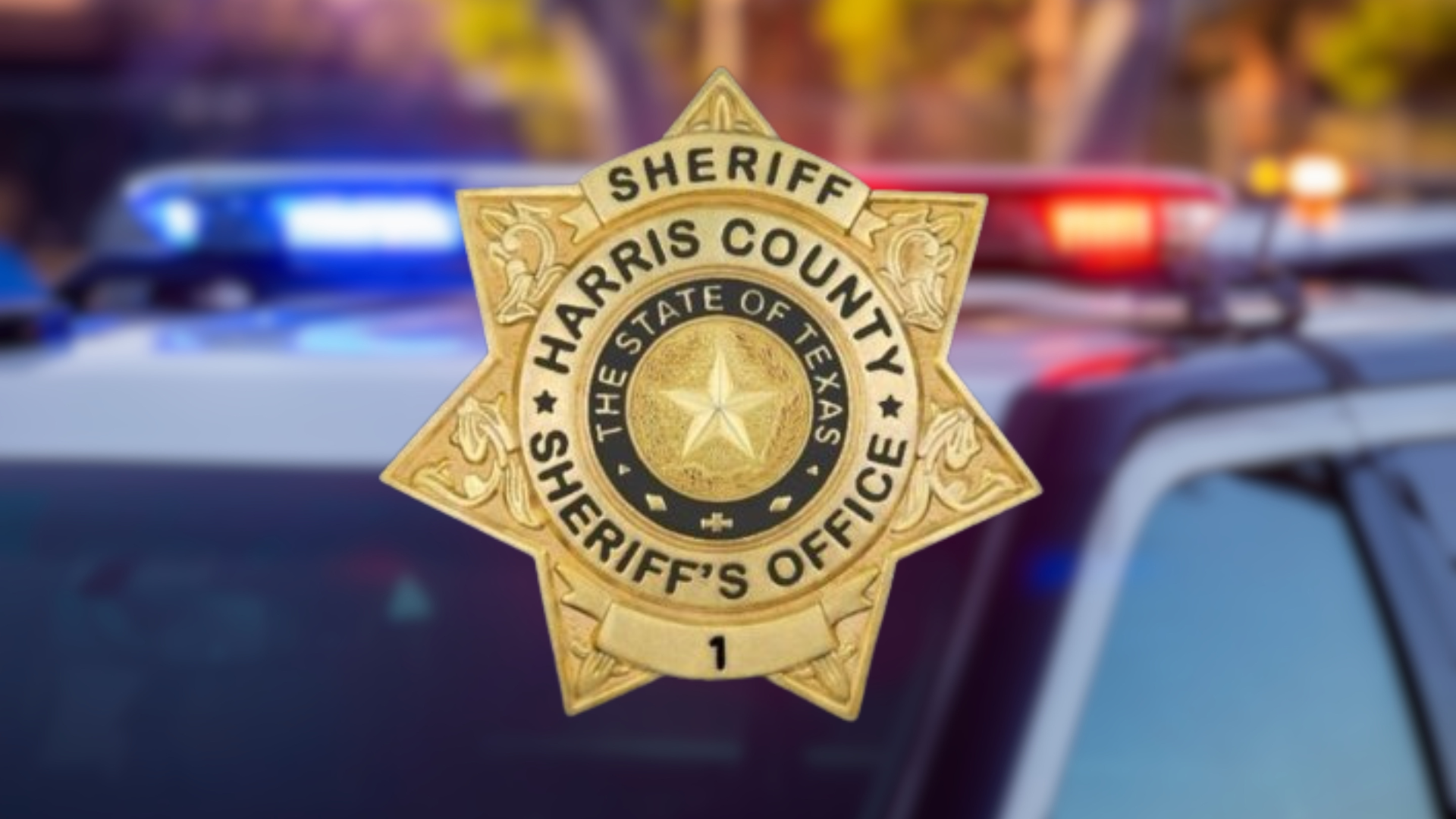 Golden police badge with the text "Harris COunty Sheriff's Office" on blurred police vehicle background.