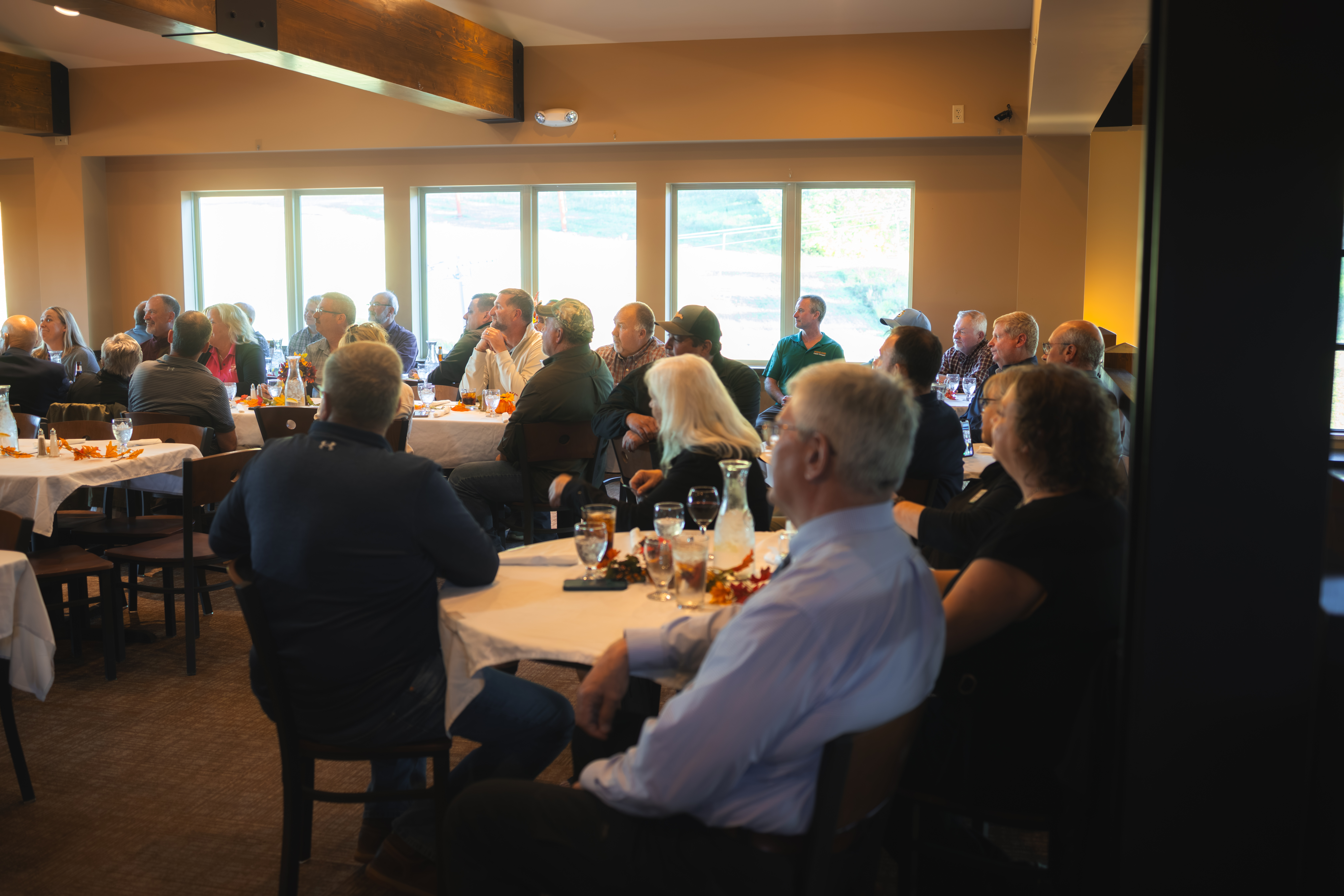 Community members and local leaders gather at round tables during the Copperwood grant celebration at Big Powderhorn Mountain Resort.
