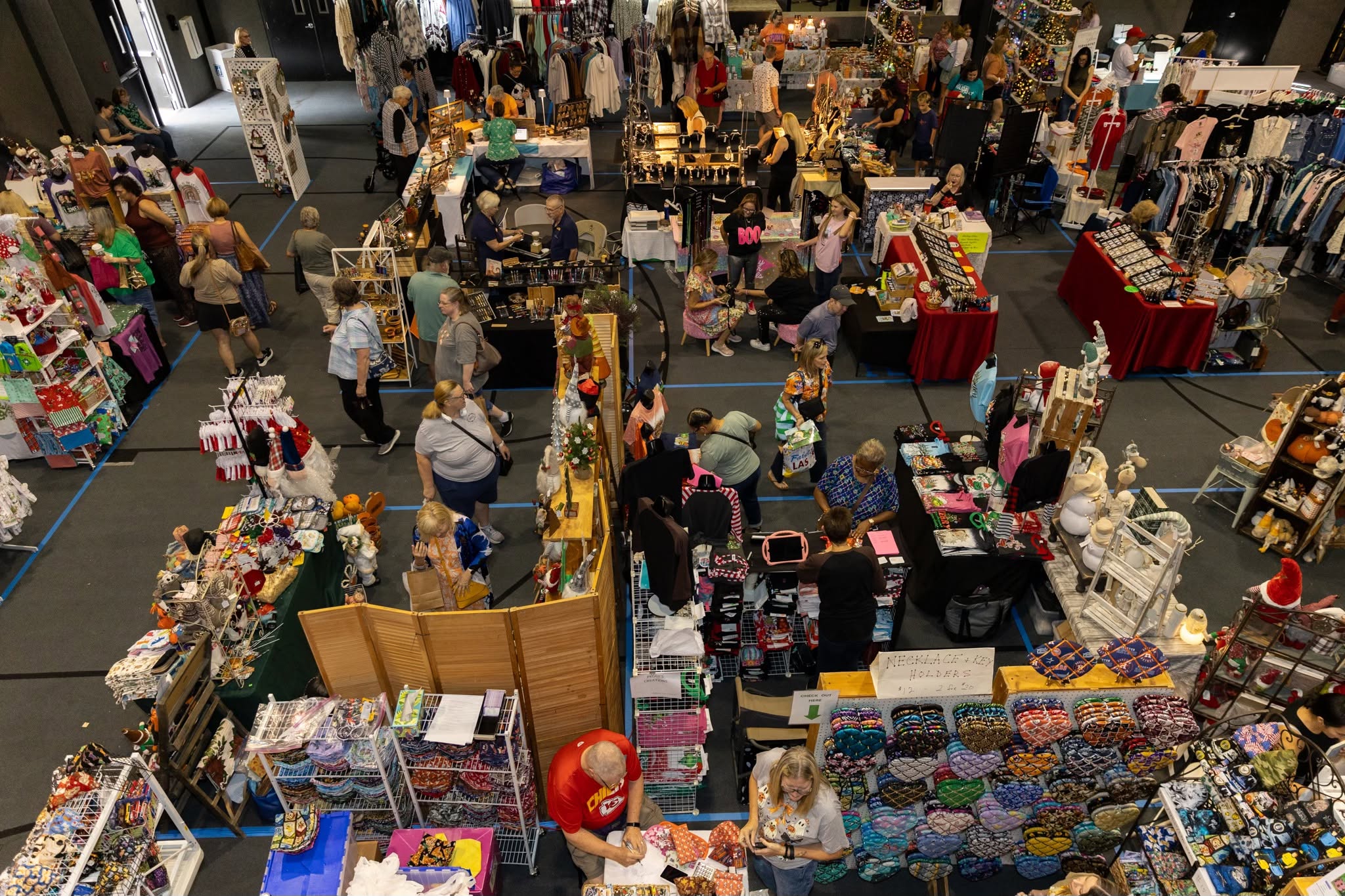 Vendors and shoppers fill a space for annual market.