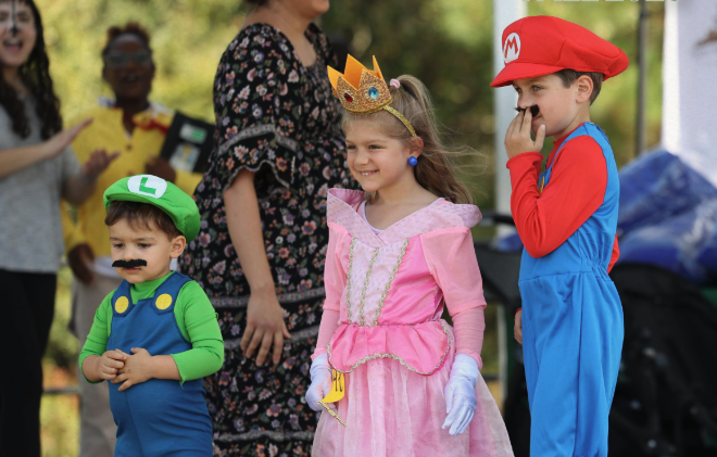 Boys and girls dressed up in costumes for Halloween