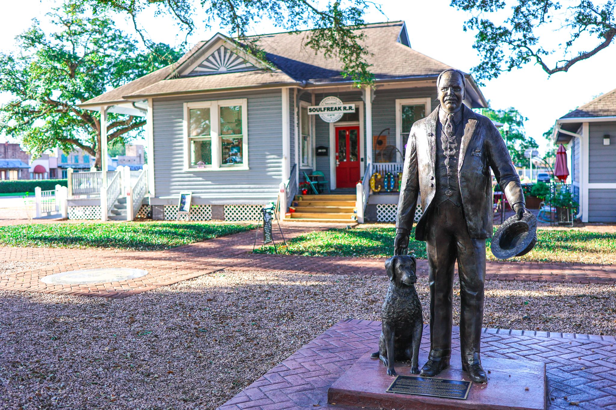  Bronze statue of J.C. League and his dog, Scout, located in League Park within the Historic District of League City, Texas.