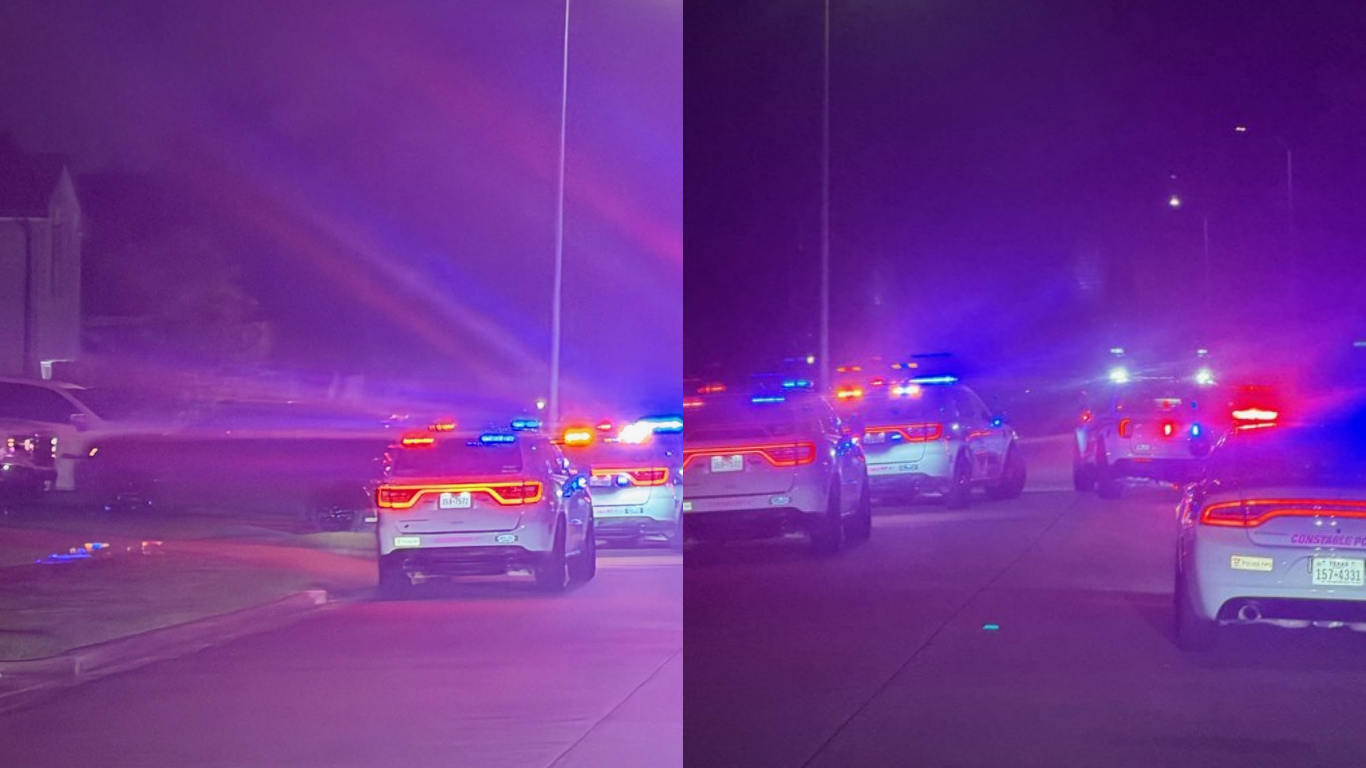Police cruiser on scene of a shooting with emergency lights on their cruisers.
