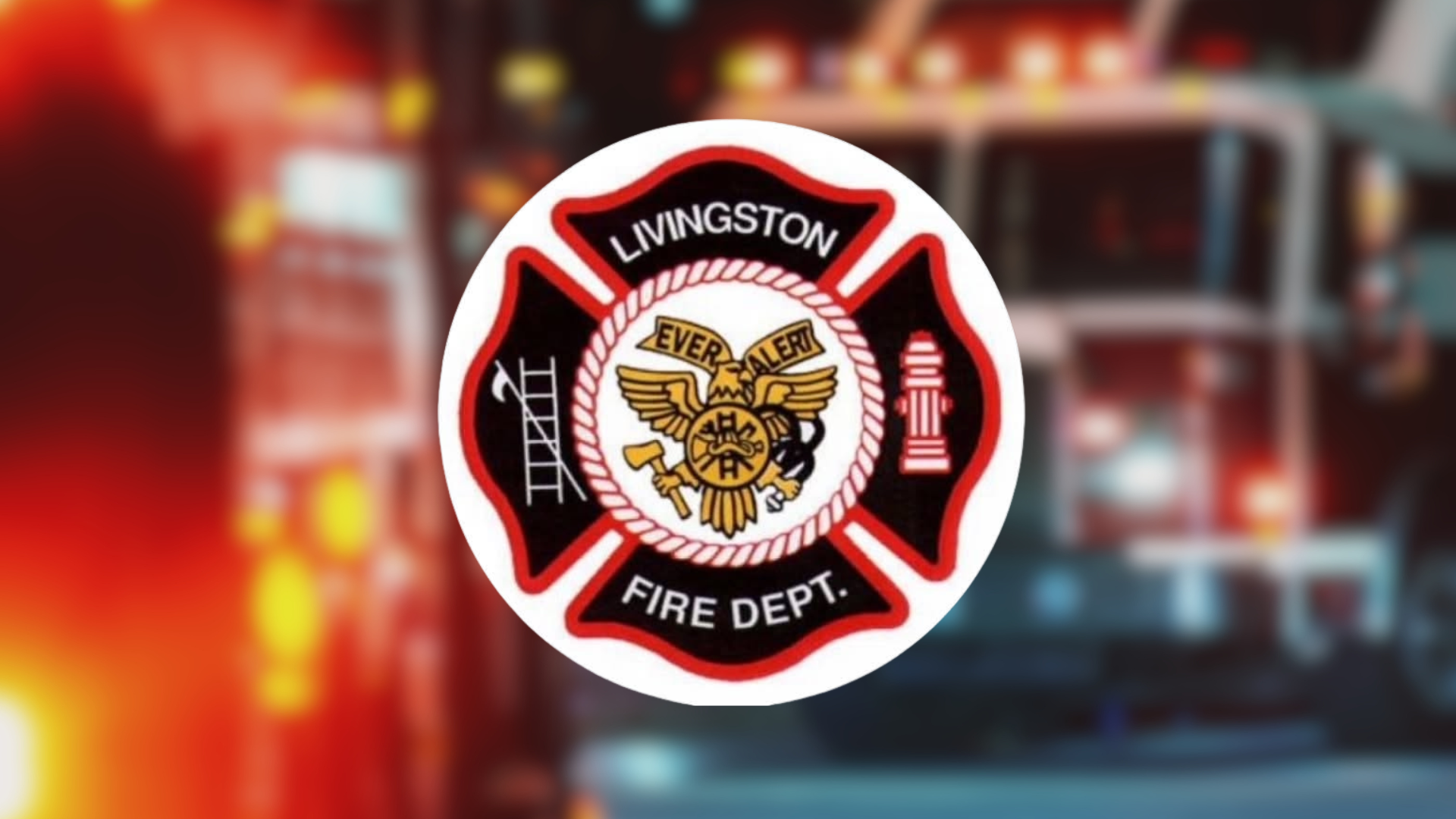Livingston NJ Fire Department logo with background of blurred two red fire trucks with emergency lights on.
