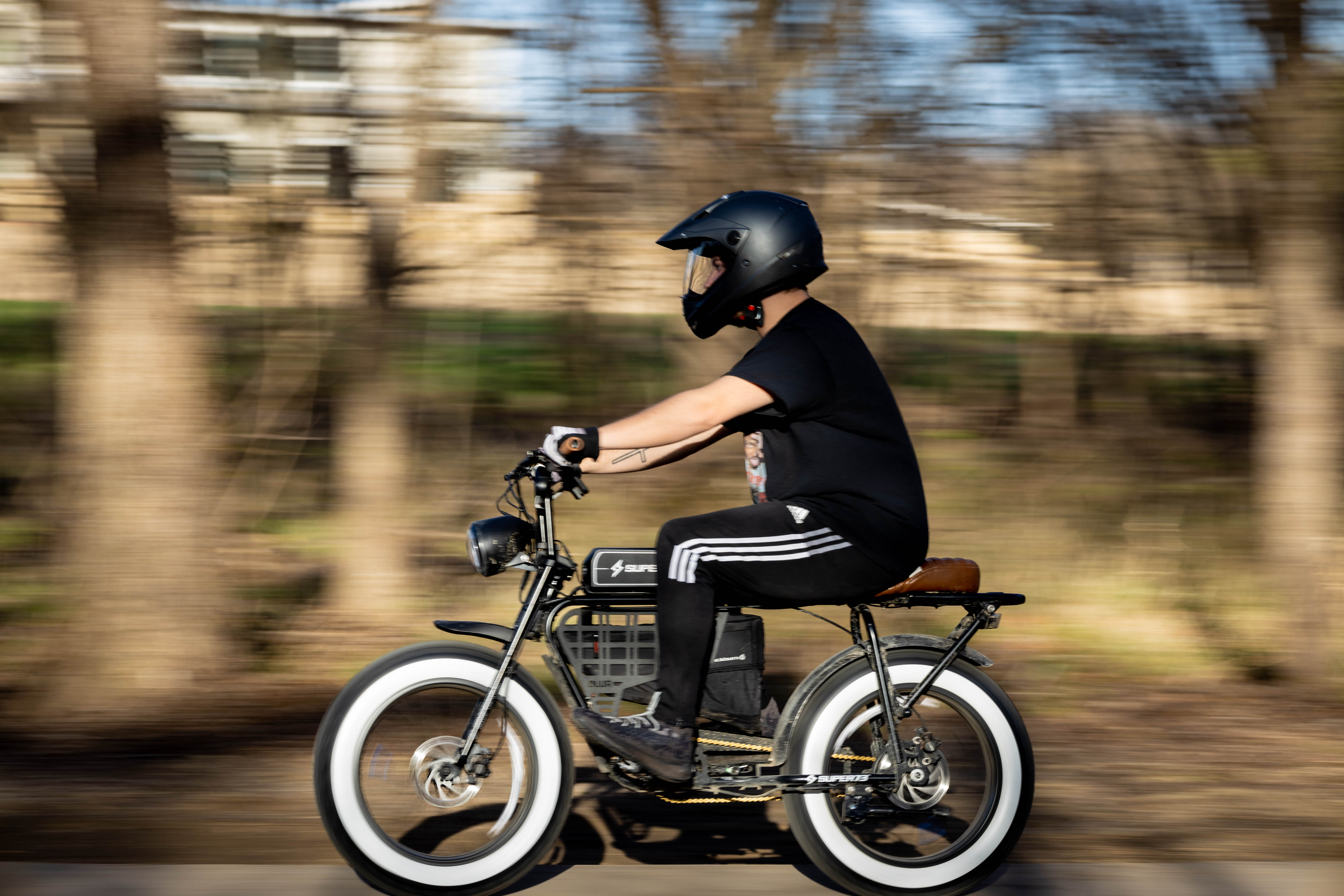 A person riding an electric bicycle outdoors.
