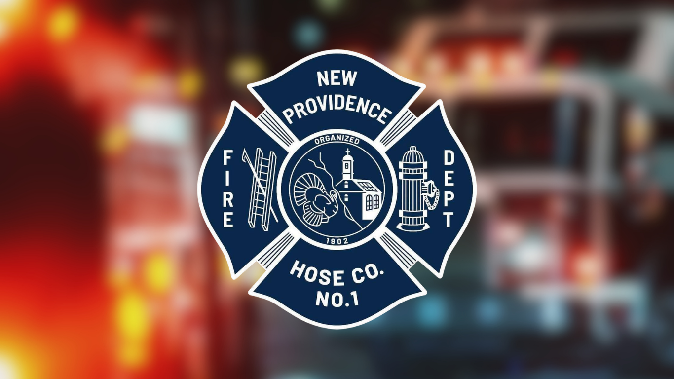 Logo for New Providence Fire Department on firetruck background blurred.