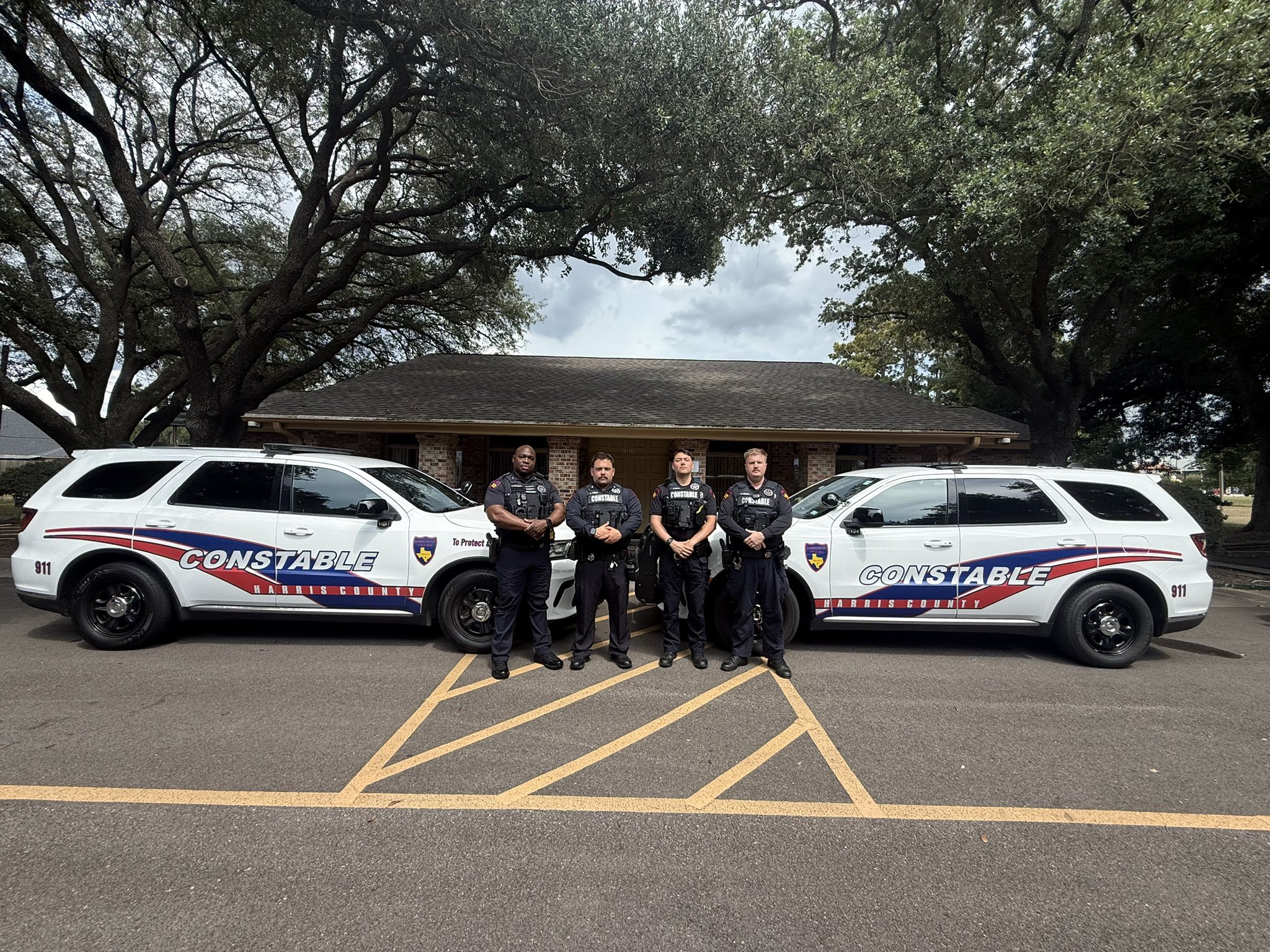 Officers standing next to their police cruisers posing for photo ahead of traffic enforcement.