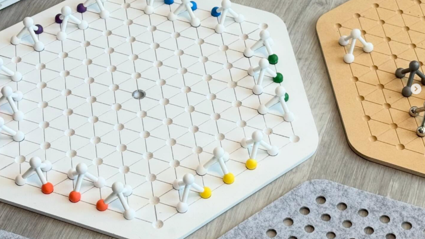 White board game with multiple colorful pieces. 