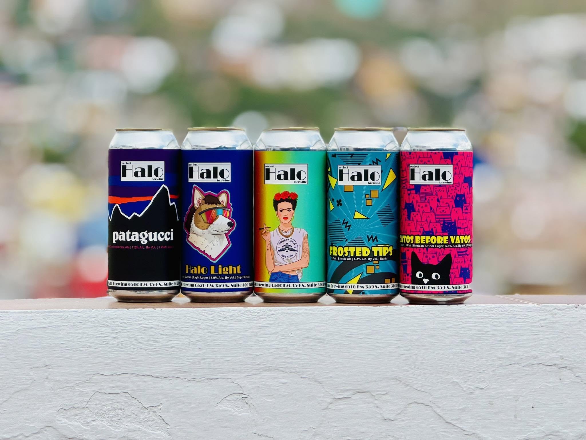 Beer cans lined up in front of blurred background