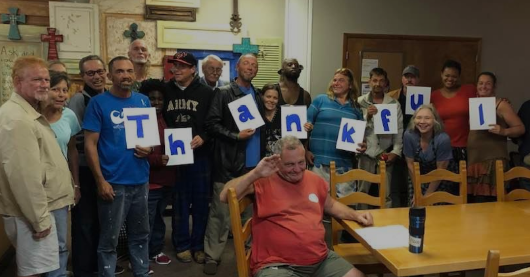 A group at Remnant Cafe holds letters spelling “Thankful.”