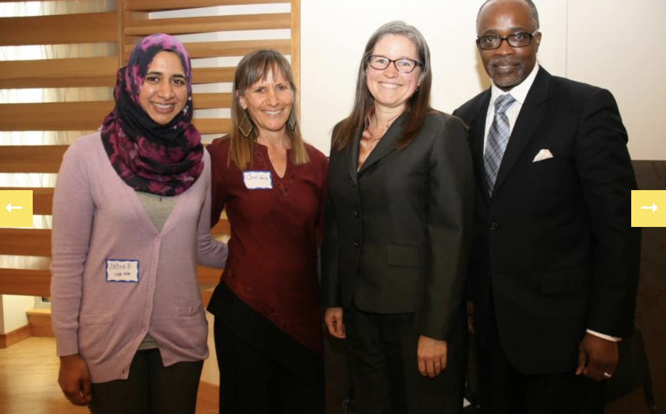 Four people smiling together at a Marin Interfaith Council Cooperation Circle event.