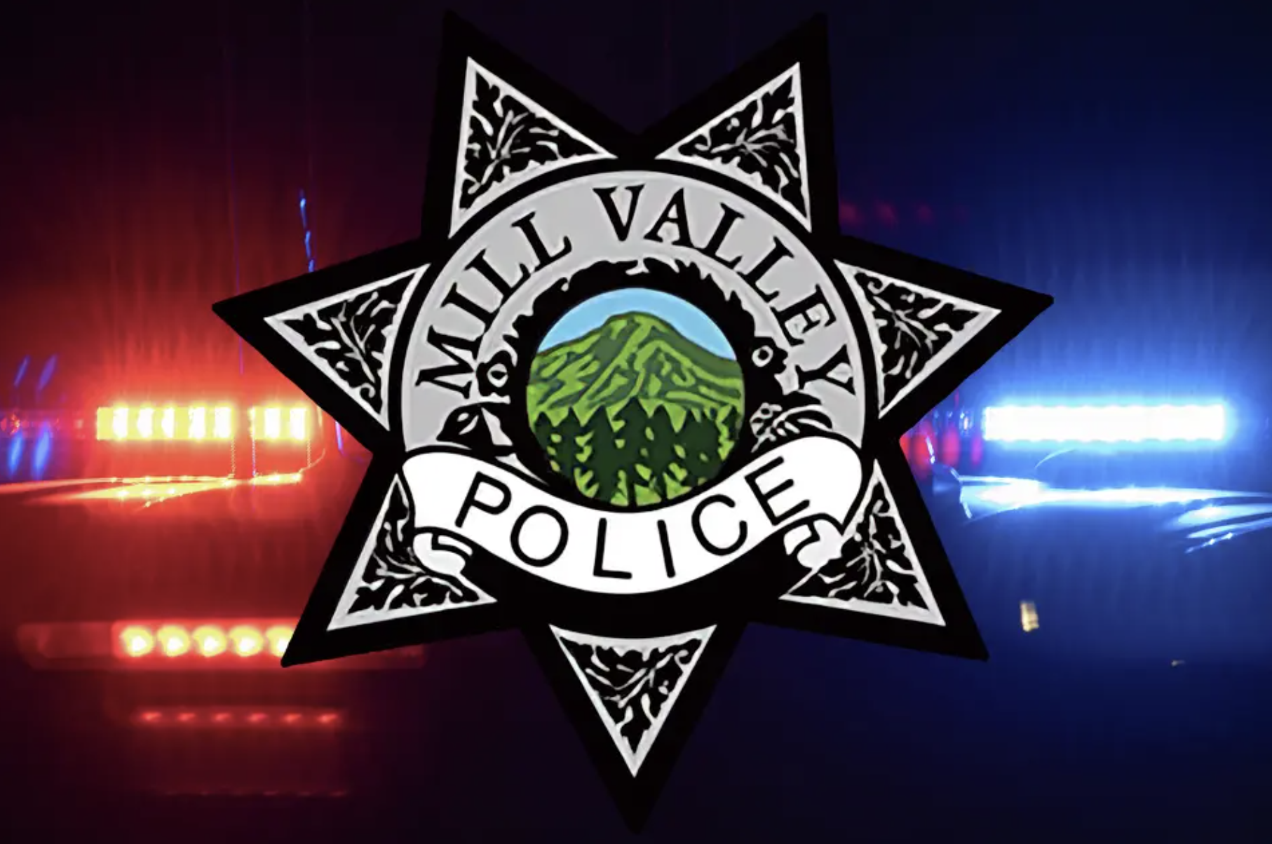 Mill Valley Police Department badge logo with Mount Tamalpais at its center, overlaid on a background of red and blue police lights.