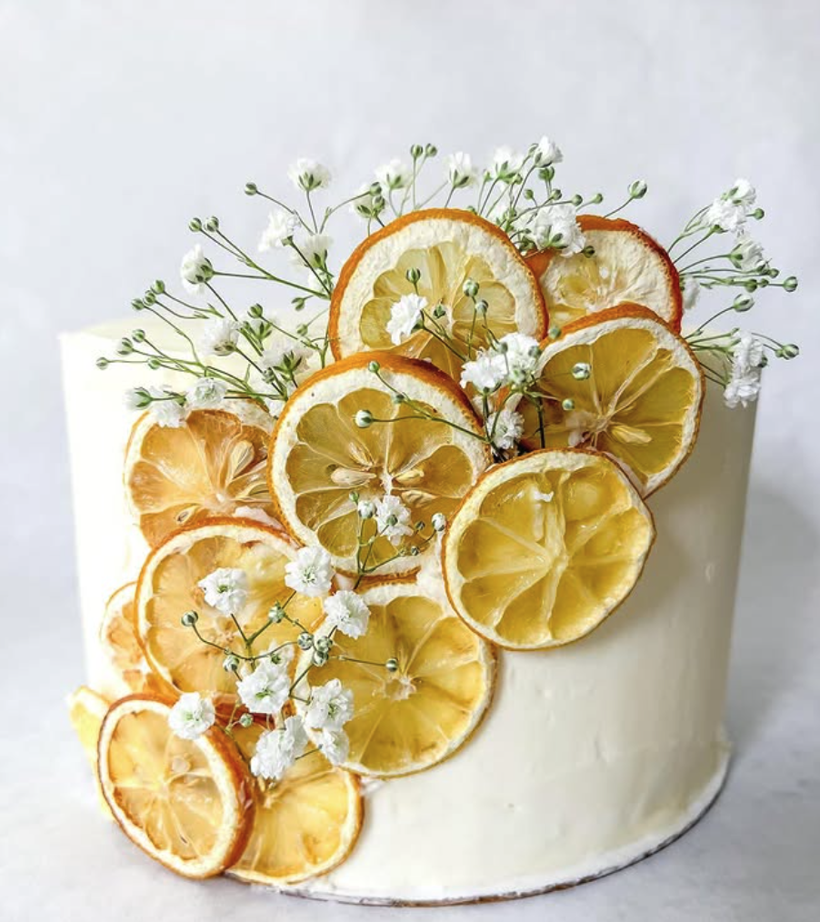 Decorative cake with lemons and flowers ready for event.