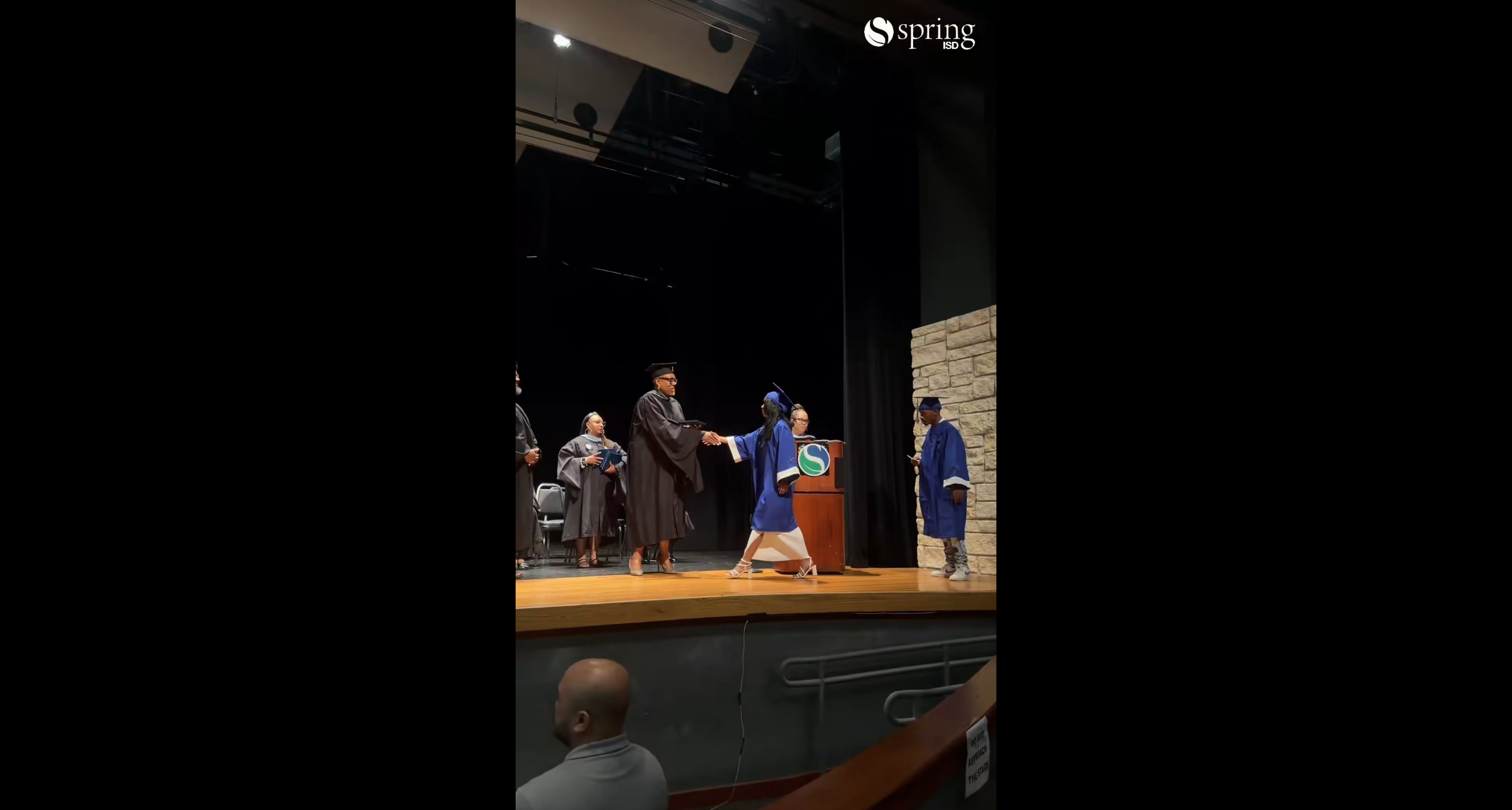 Student graduates cross stage for moving up ceremony.