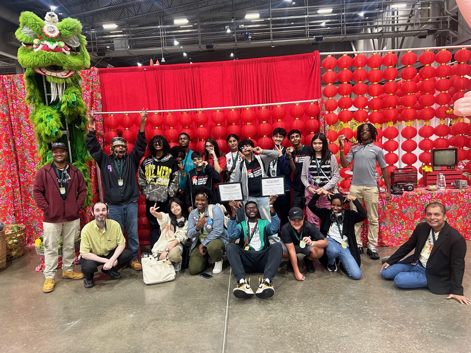 Students and staff gather for celebration after robotics team win.