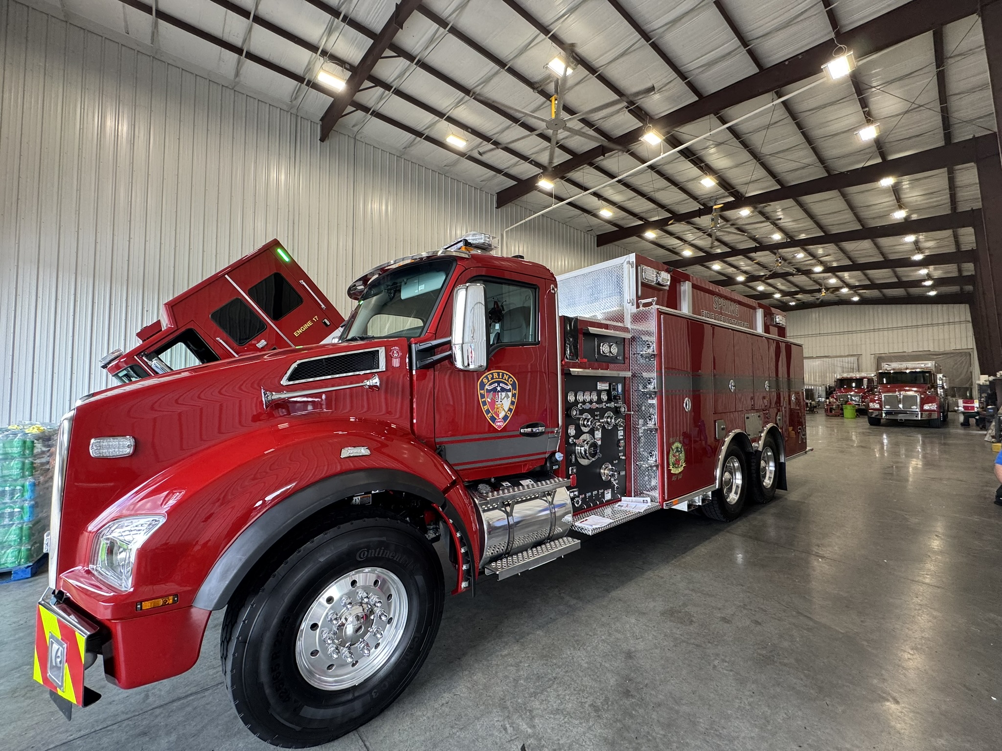 New red fire truck inside department building.