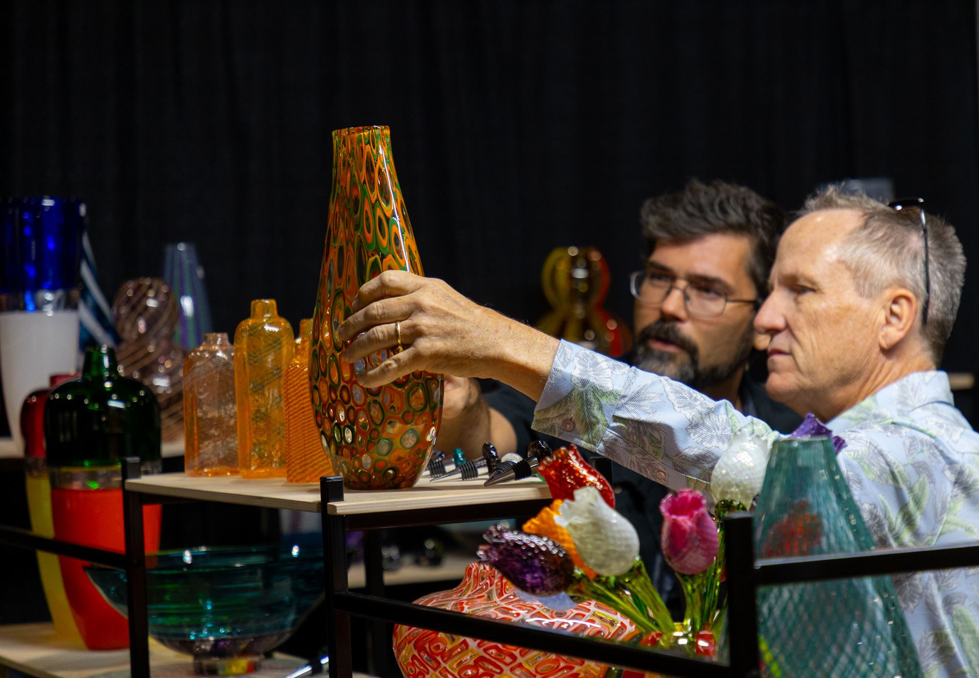 Two men looking at art at The Woodlands Fine Craft, Art & Design Show in Texas