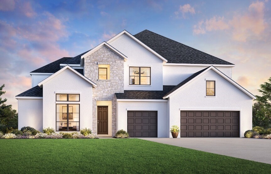 White home with stone, black windows, and brown garage.