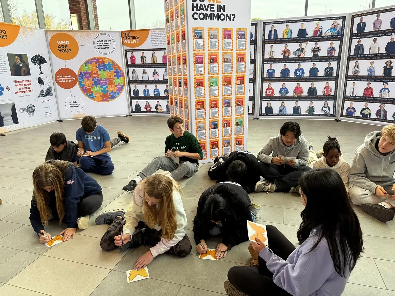 Group of students writing and creating art together in an academic setting