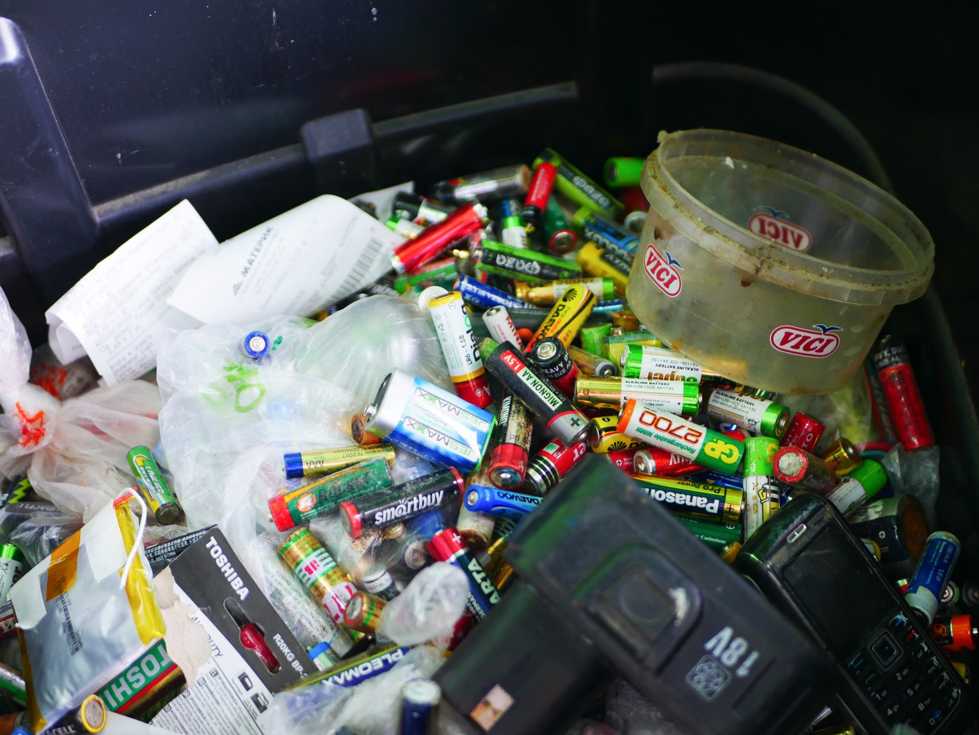 Spent batteries in a recycling bin
