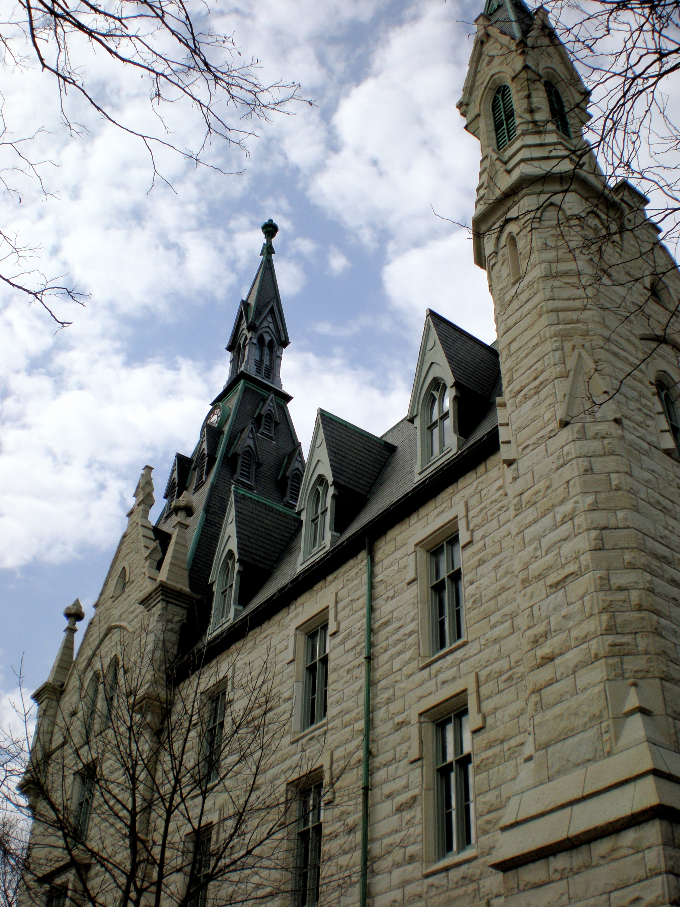 Gothic Revival stone building with pointed spires and arched windows on a university campus.