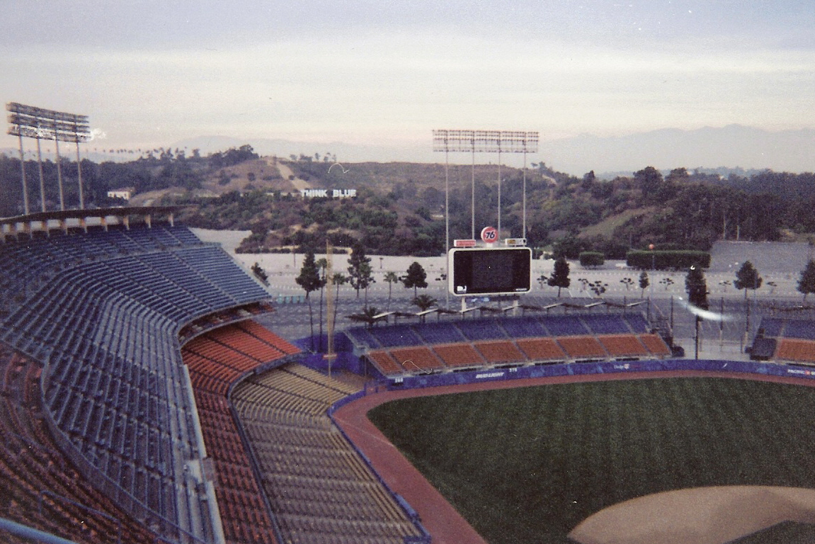 Elevated view of an empty baseball stadium showing the diamond and blue seats.