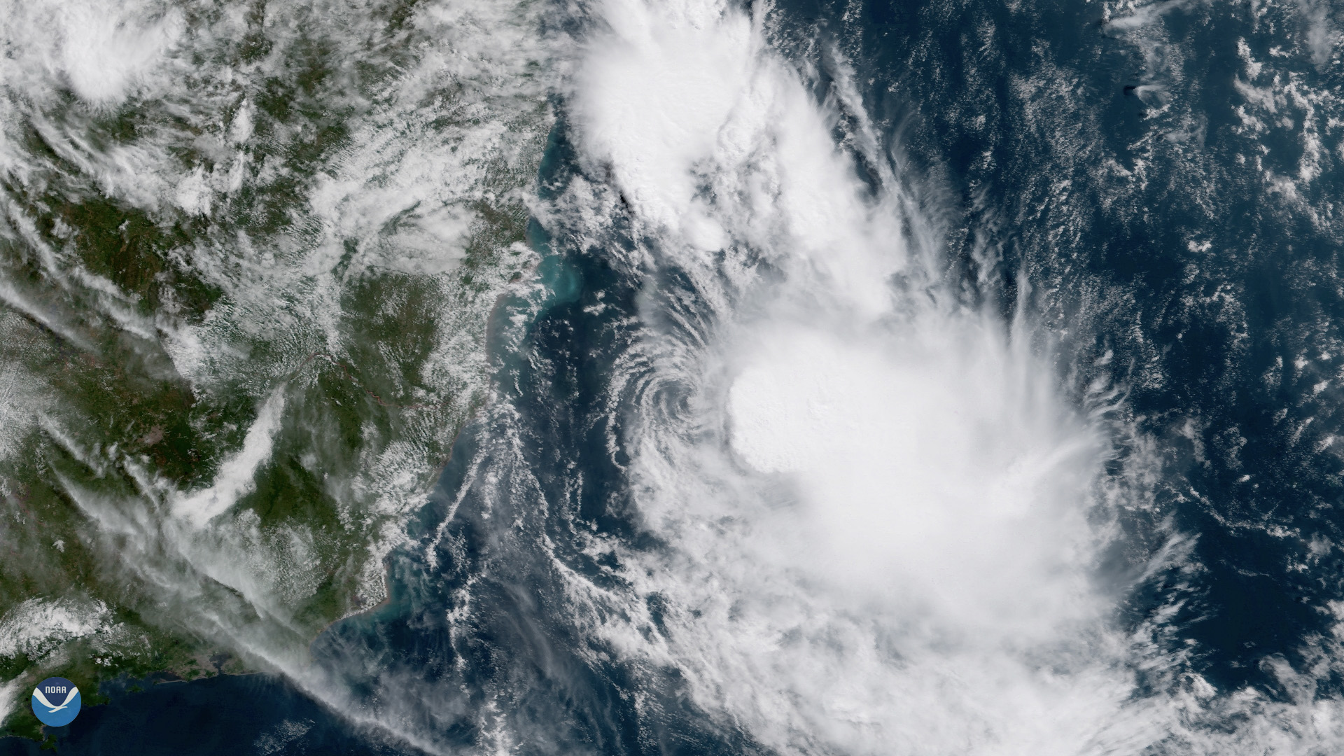 Satellite image of a swirling tropical storm system over the Atlantic Ocean.