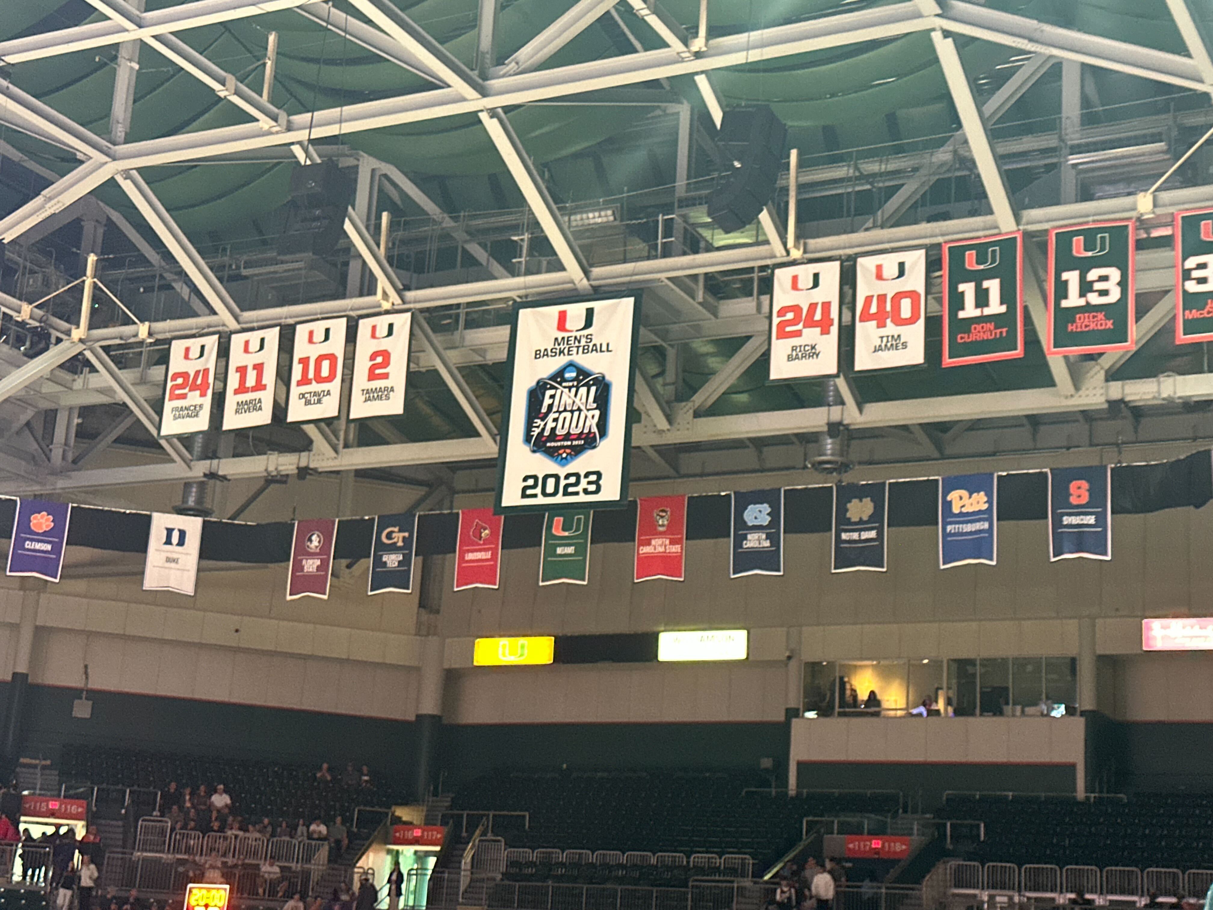 Arena interior with championship banners and retired numbers hanging from the rafters.