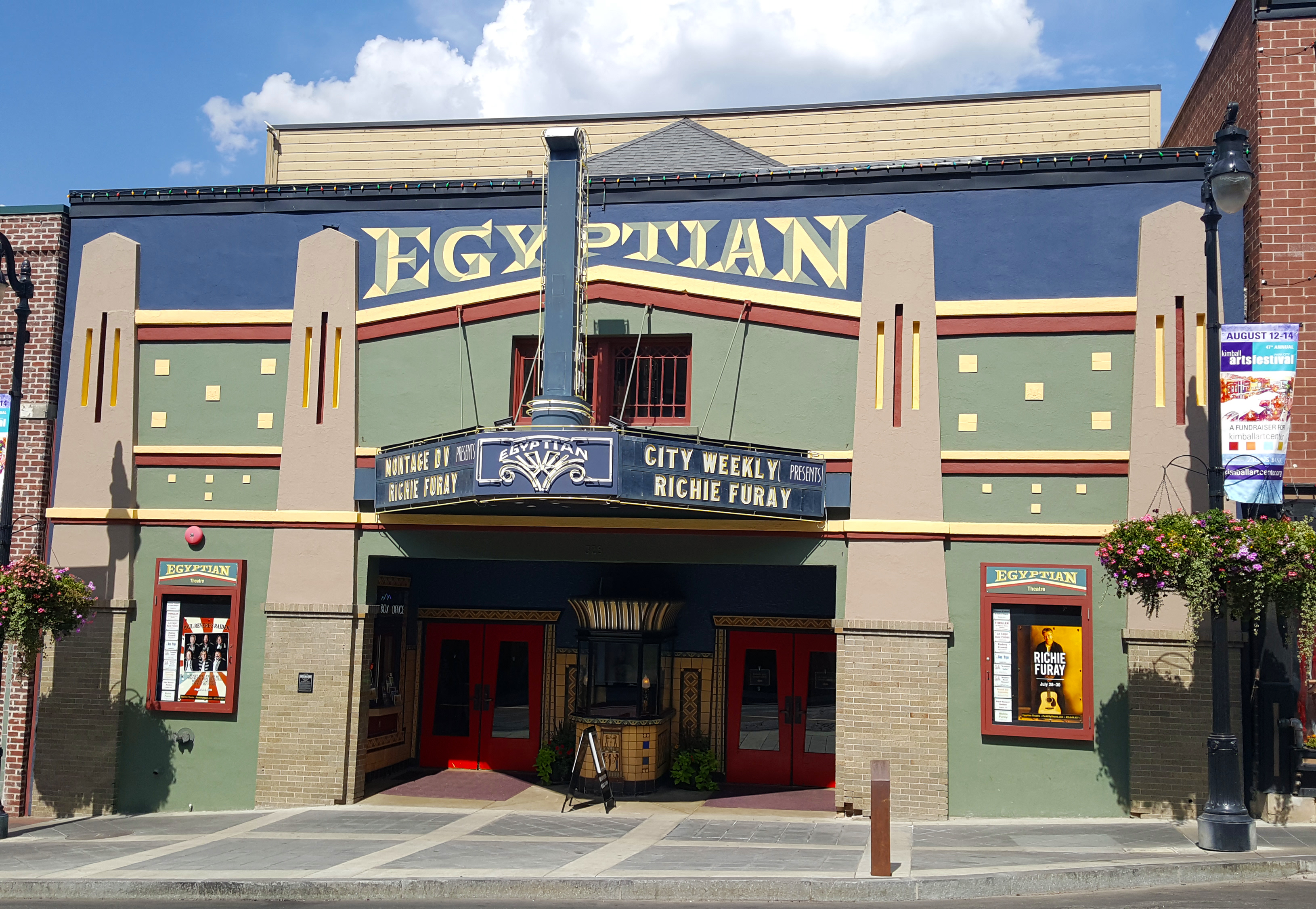 Exterior facade of the Egyptian Theatre with Art Deco styling, marquee, and red entry doors.