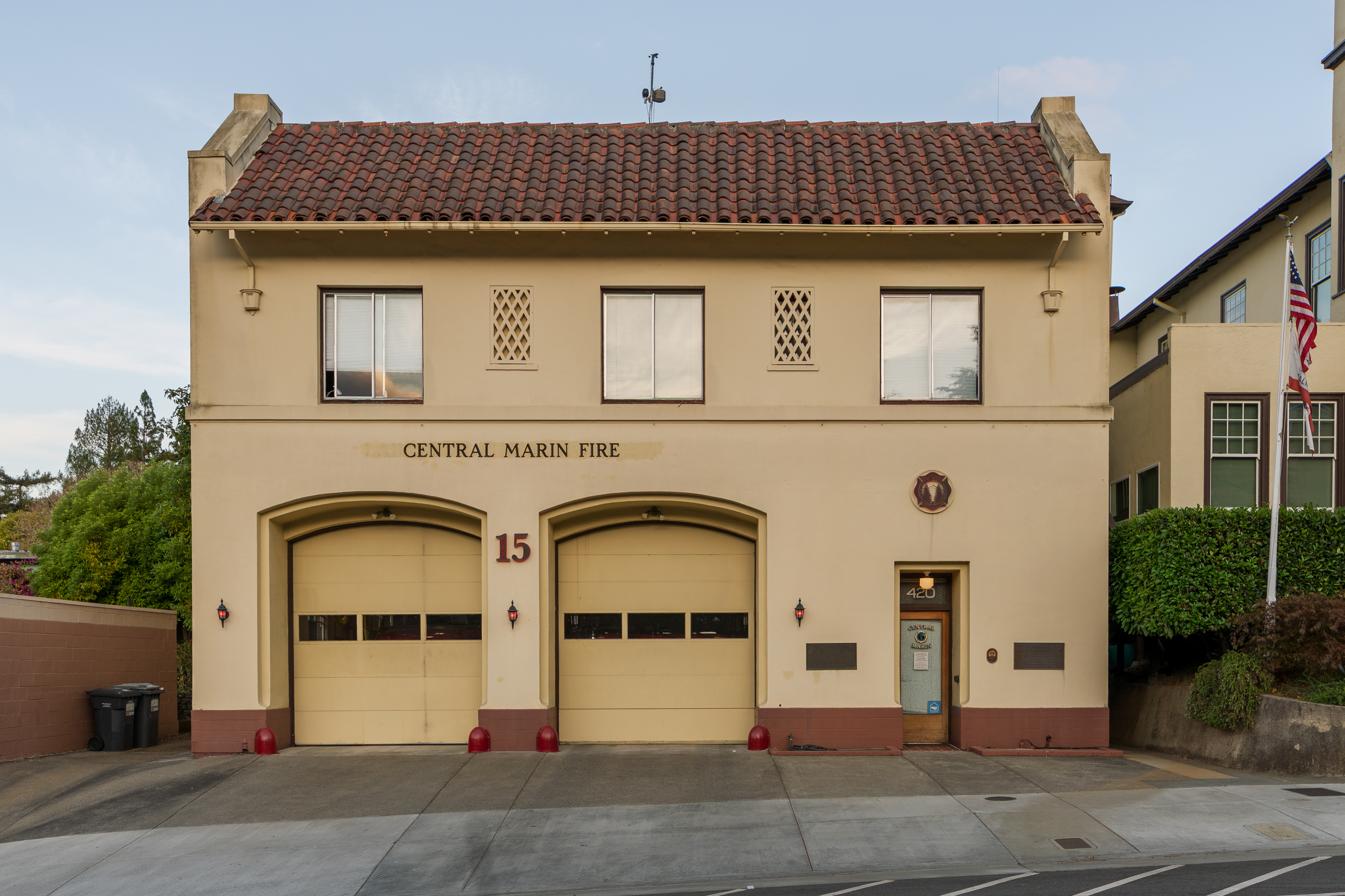 Yellow stucco fire station with two garage bays labeled Central Marin Fire, number 15.