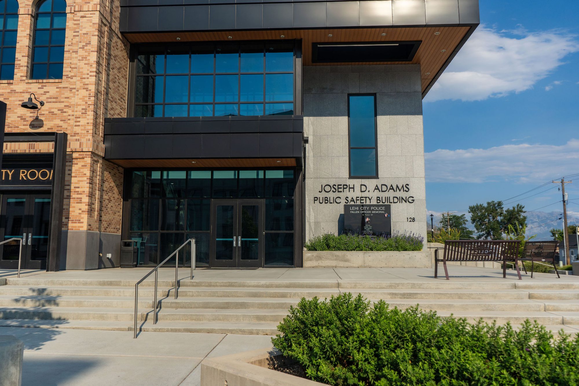 Modern public safety building exterior with brick, glass, and concrete facade.