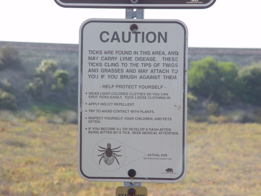 ticks caution sign at entrance to Del Mar / Carmel Valley Road trail at Los Penasquitos Lagoon