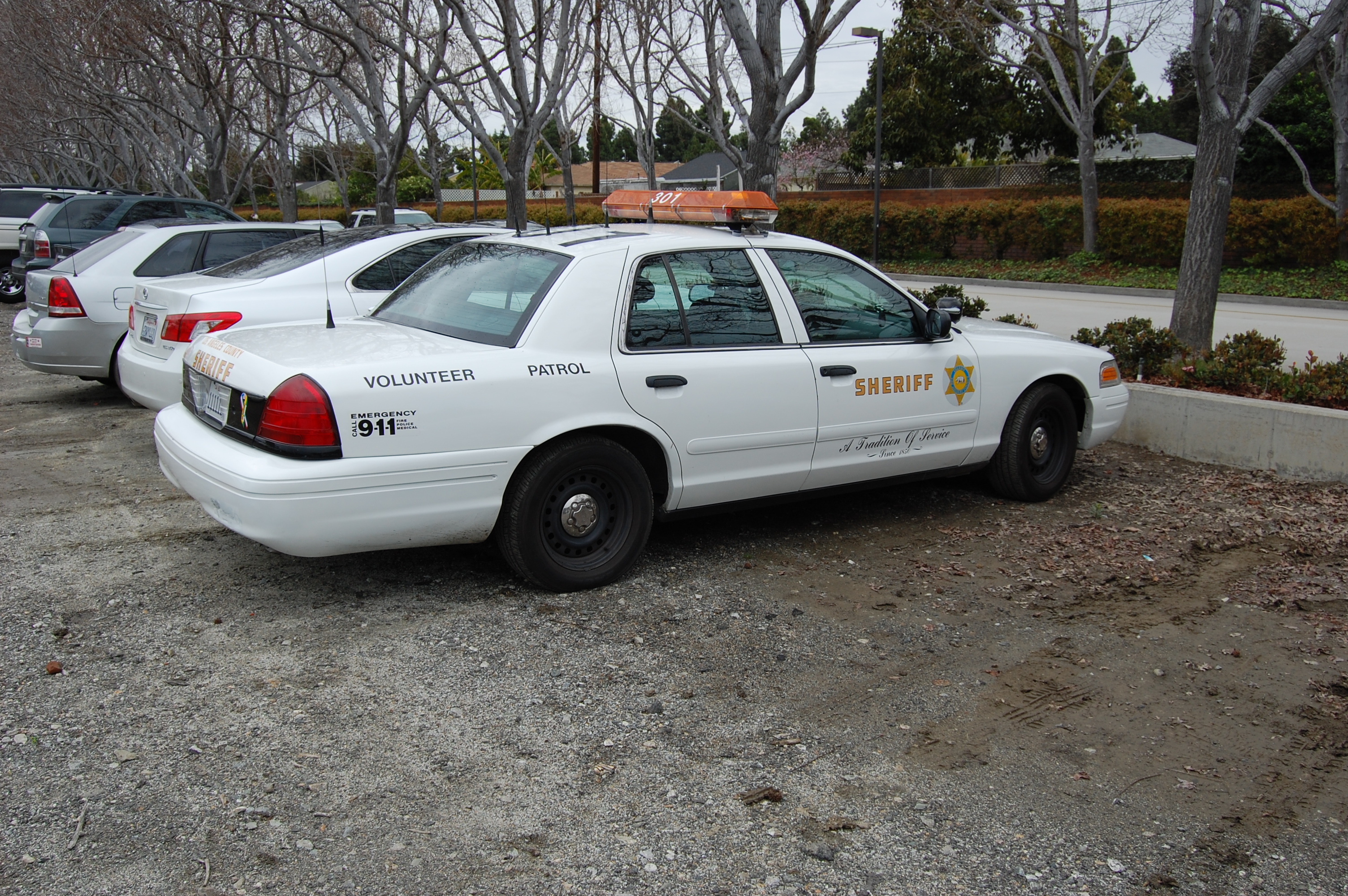 A white Los Angeles County Sheriff's Department volunteer patrol car parked outdoors.
