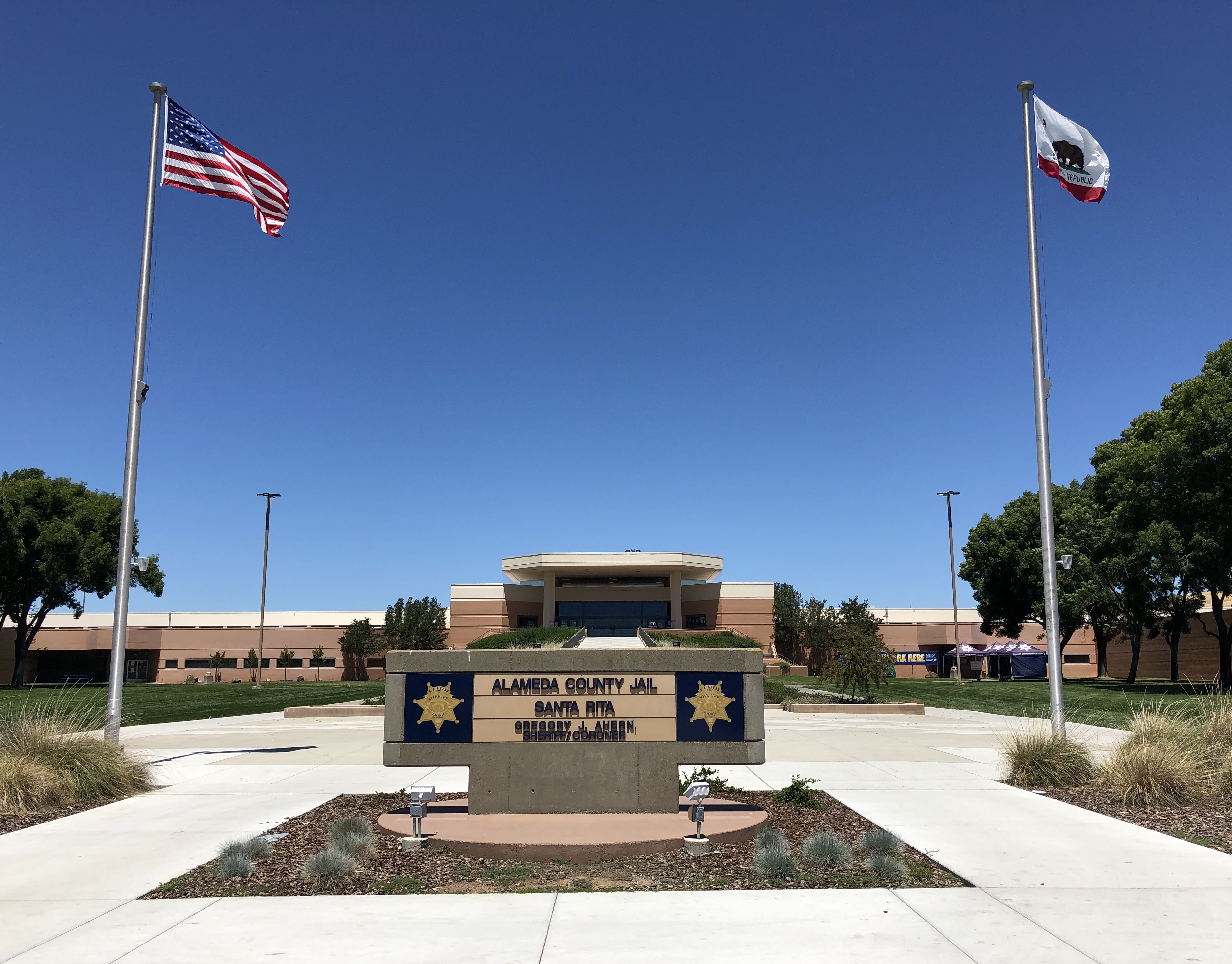 Entrance sign and building exterior of Alameda County Jail Santa Rita on a sunny day.