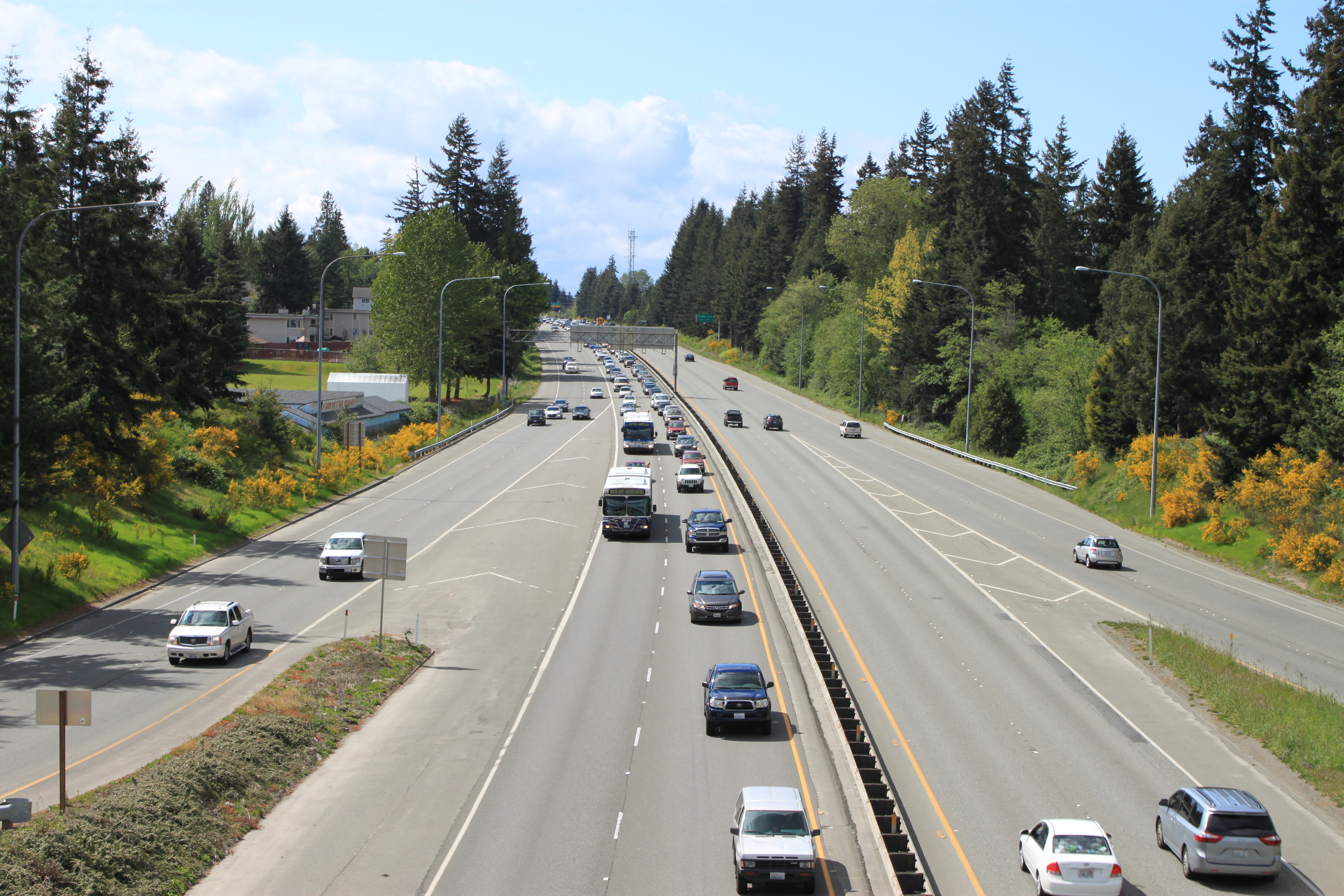 Multi-lane highway with traffic viewed from a pedestrian overpass near Evergreen Way.