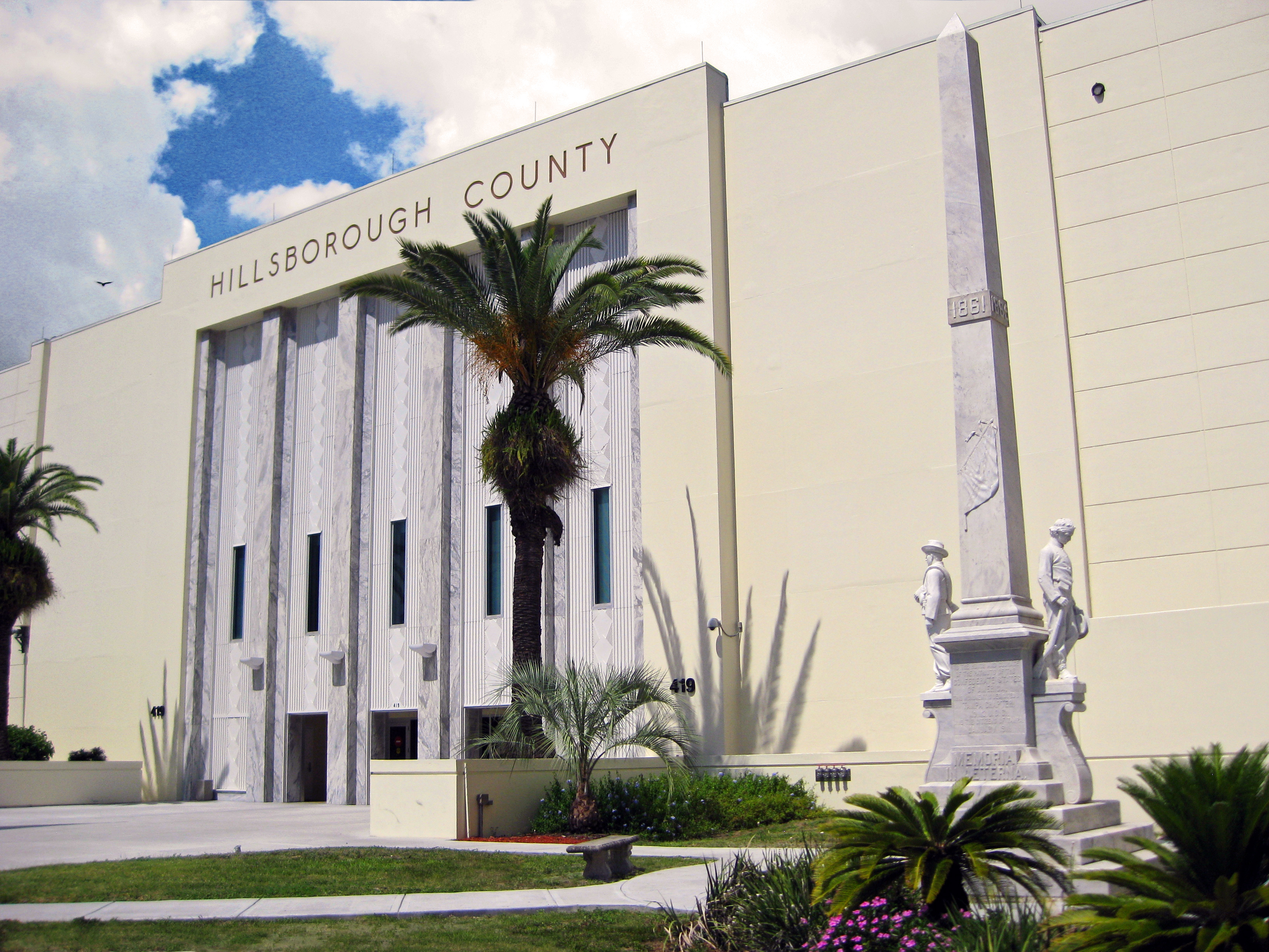 Exterior of the Hillsborough County Courthouse with a memorial monument in the foreground.