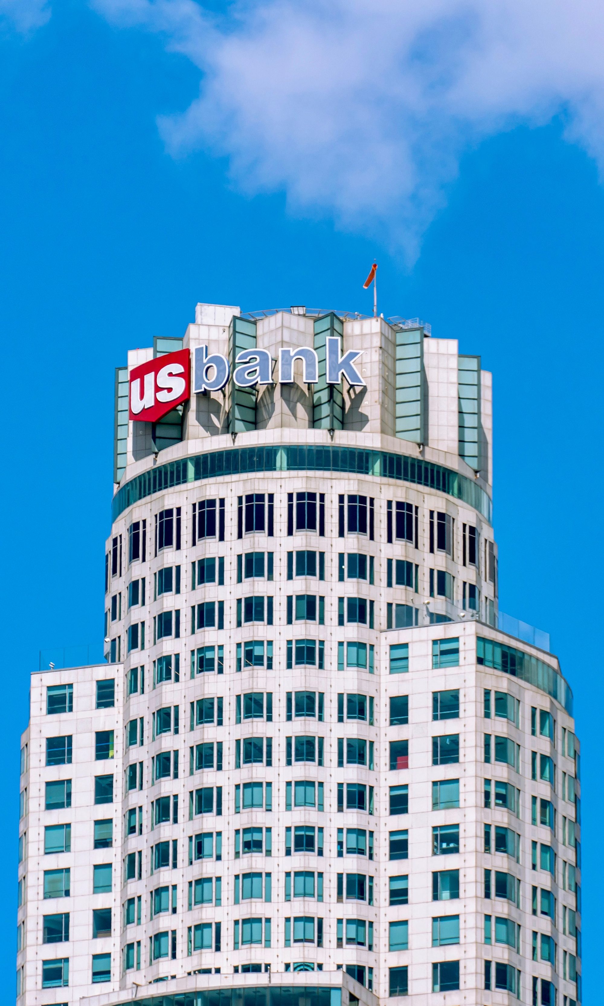 The iconic US Bank Tower in downtown Los Angeles against a clear blue sky.