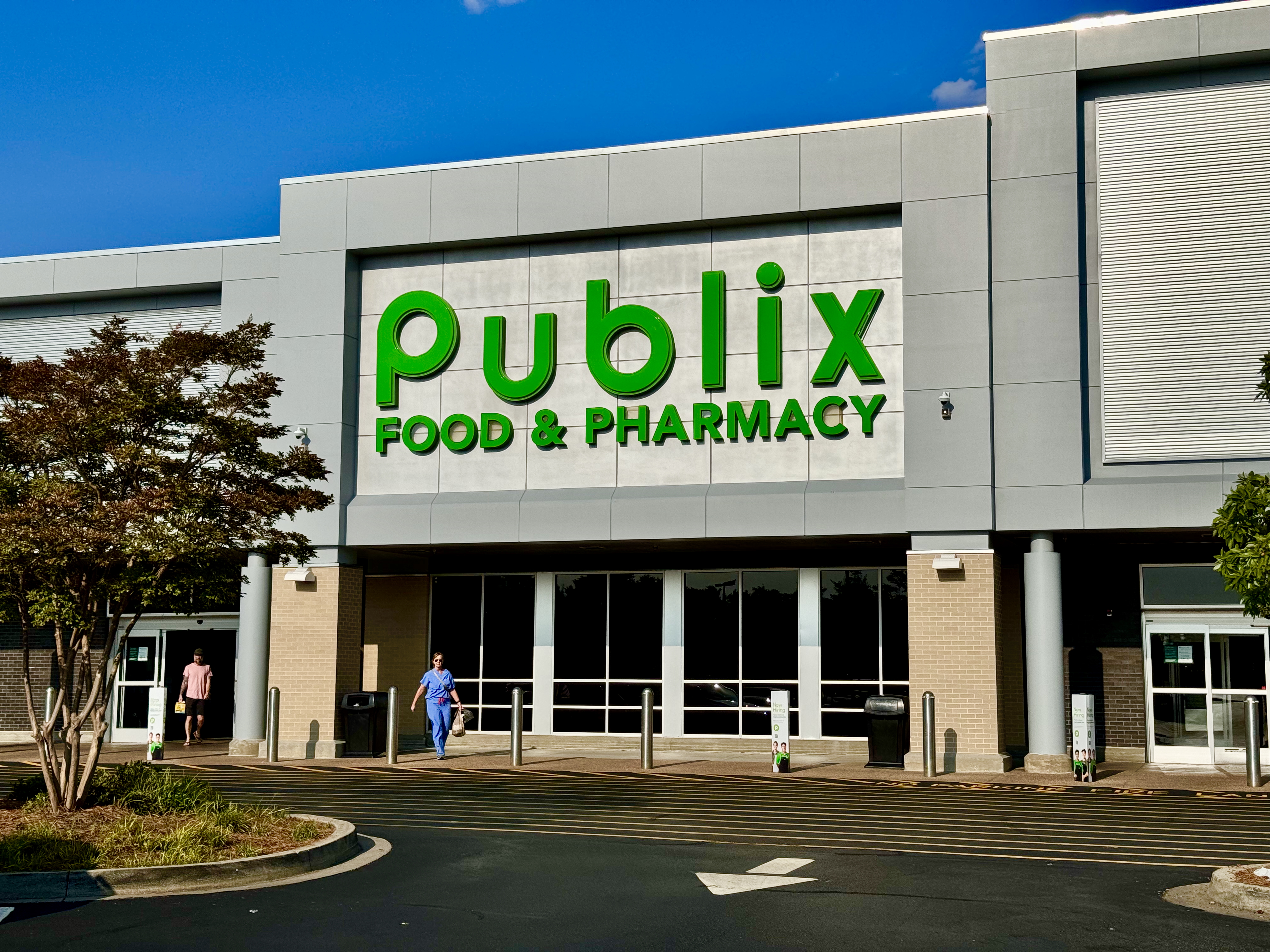 Publix Food & Pharmacy storefront with green sign, glass doors, and parking lot.