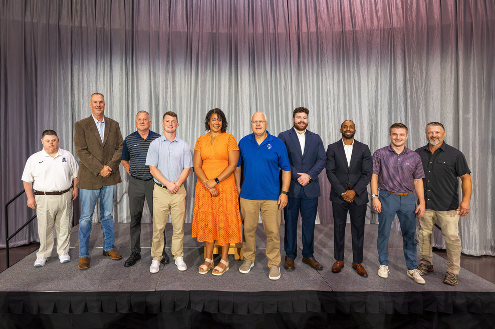 Members of Allen ISD's 2026 Athletics Hall of Honor Class stand on stage during the induction ceremony.