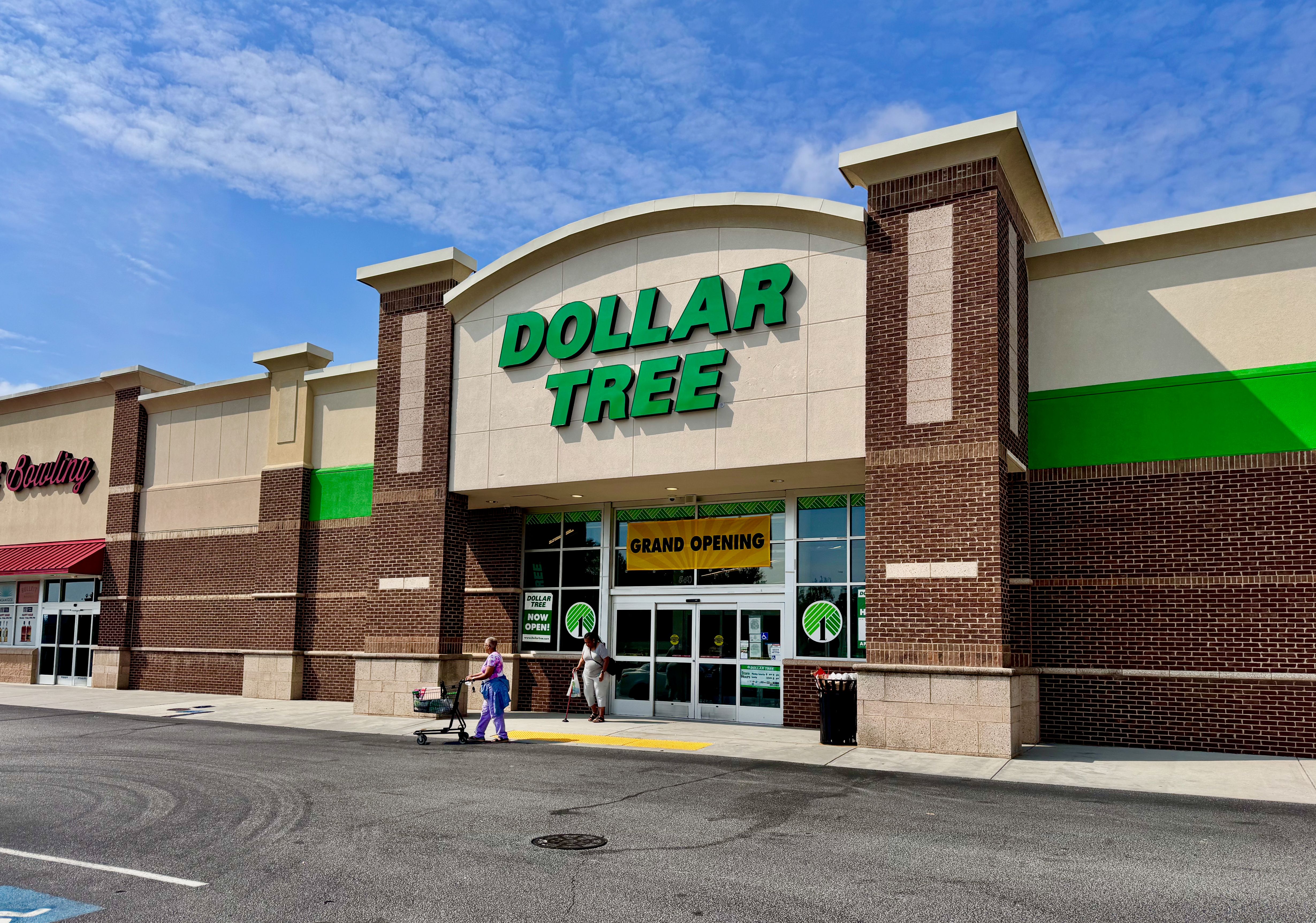 Dollar Tree store exterior with brick facade and grand opening banner at entrance.