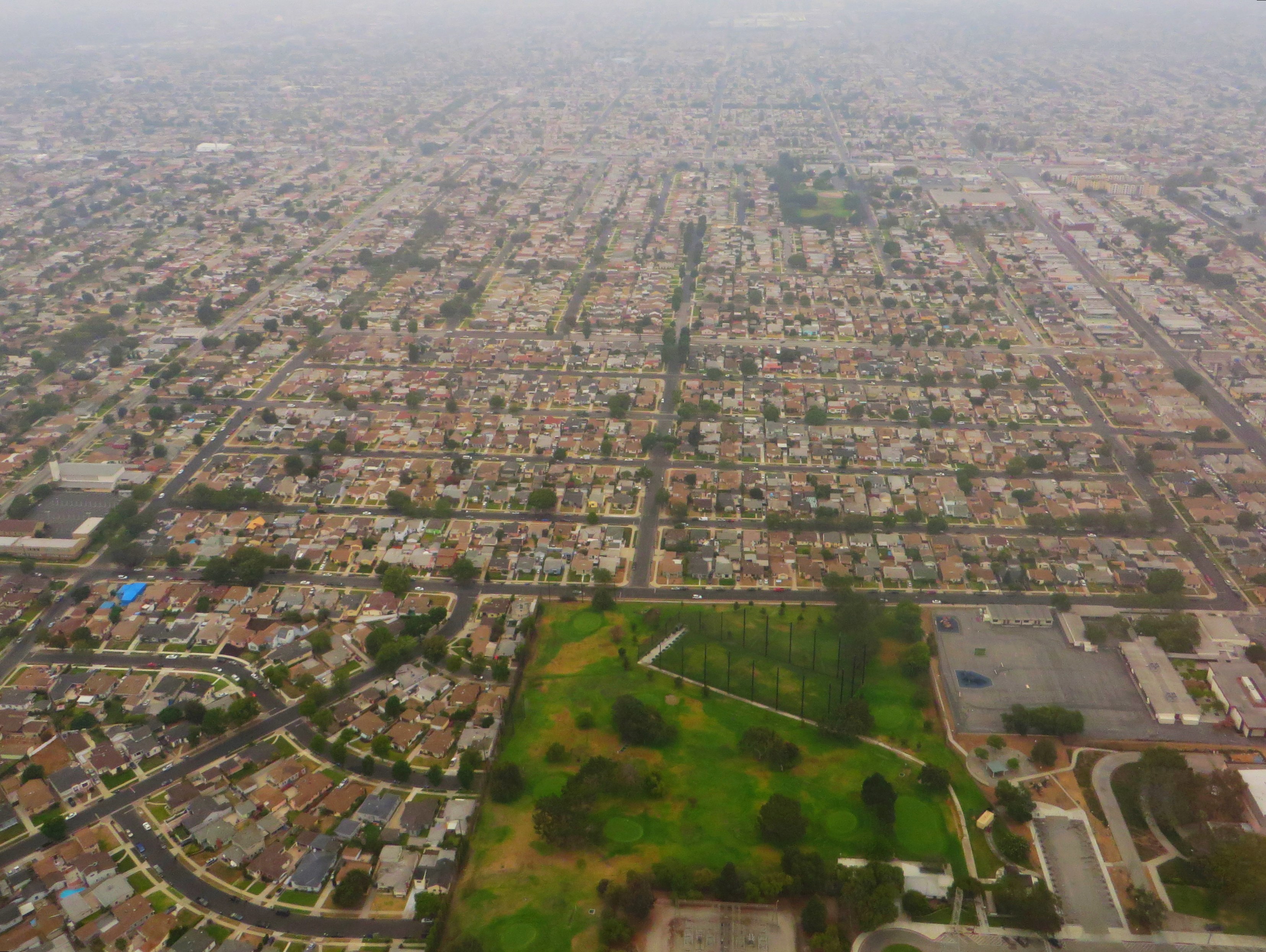 Aerial view of a dense Los Angeles neighborhood with a grid of streets and single-family homes.
